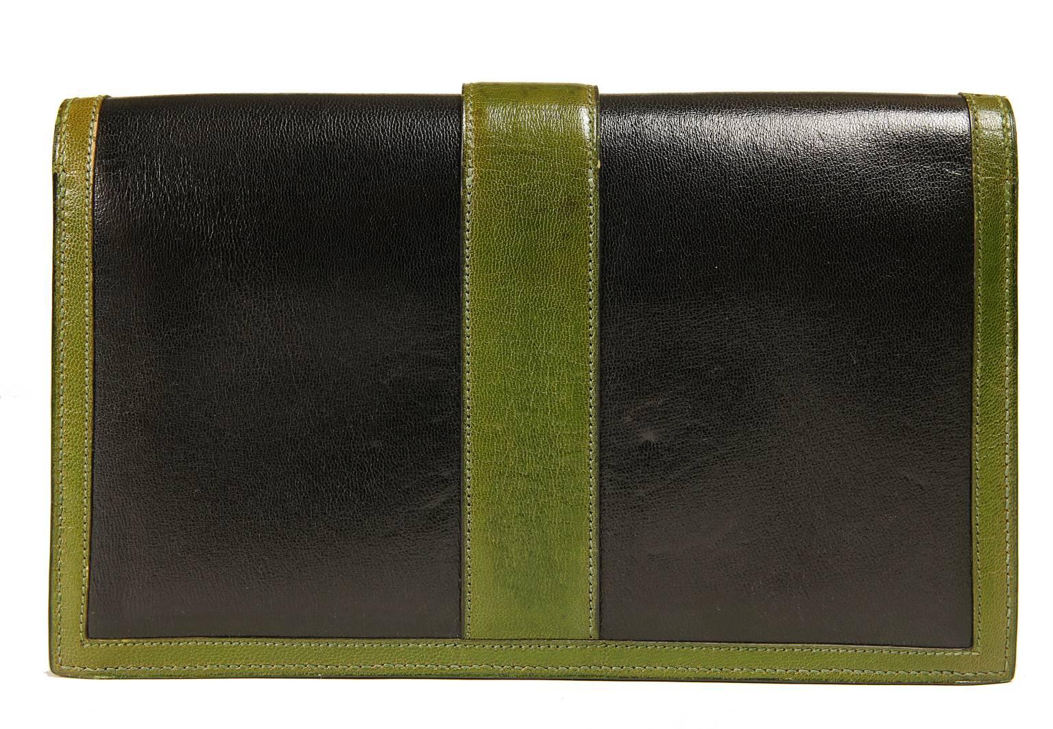 Hermès Black and Green Leather Clutch- Excellent Plus condition
  The very unique style is rarely seen and quite collectible.
 
Black leather clutch is trimmed with dark green and resembles the Jige clutch in silhouette and closure.  Two gold