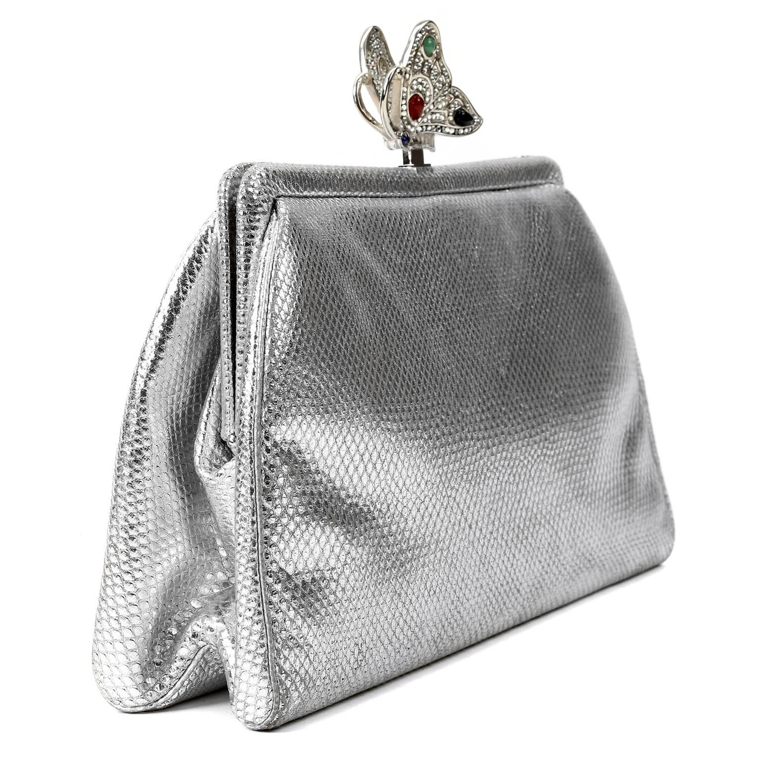 Judith Leiber Silver Lizard Clutch- excellent condition other than a small pen mark on the interior lining.  
The jeweled butterfly sitting atop the clutch elevates this lovely bag to a piece of art.
 
Metallic silver lizard skin clutch is