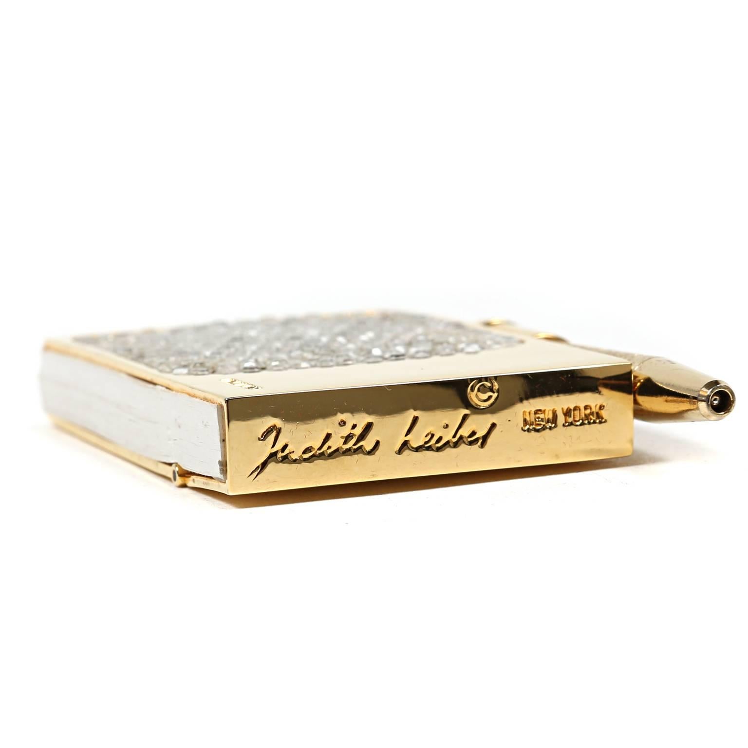 Judith Leiber Crystal Mini Pad- NEW
  The perfect gift for the woman who has everything, this demure notepad oozes luxury.
Gold tone hard cased mini notepad is encrusted with crystals.  Hinged top flips up to access a small pad of white paper. 