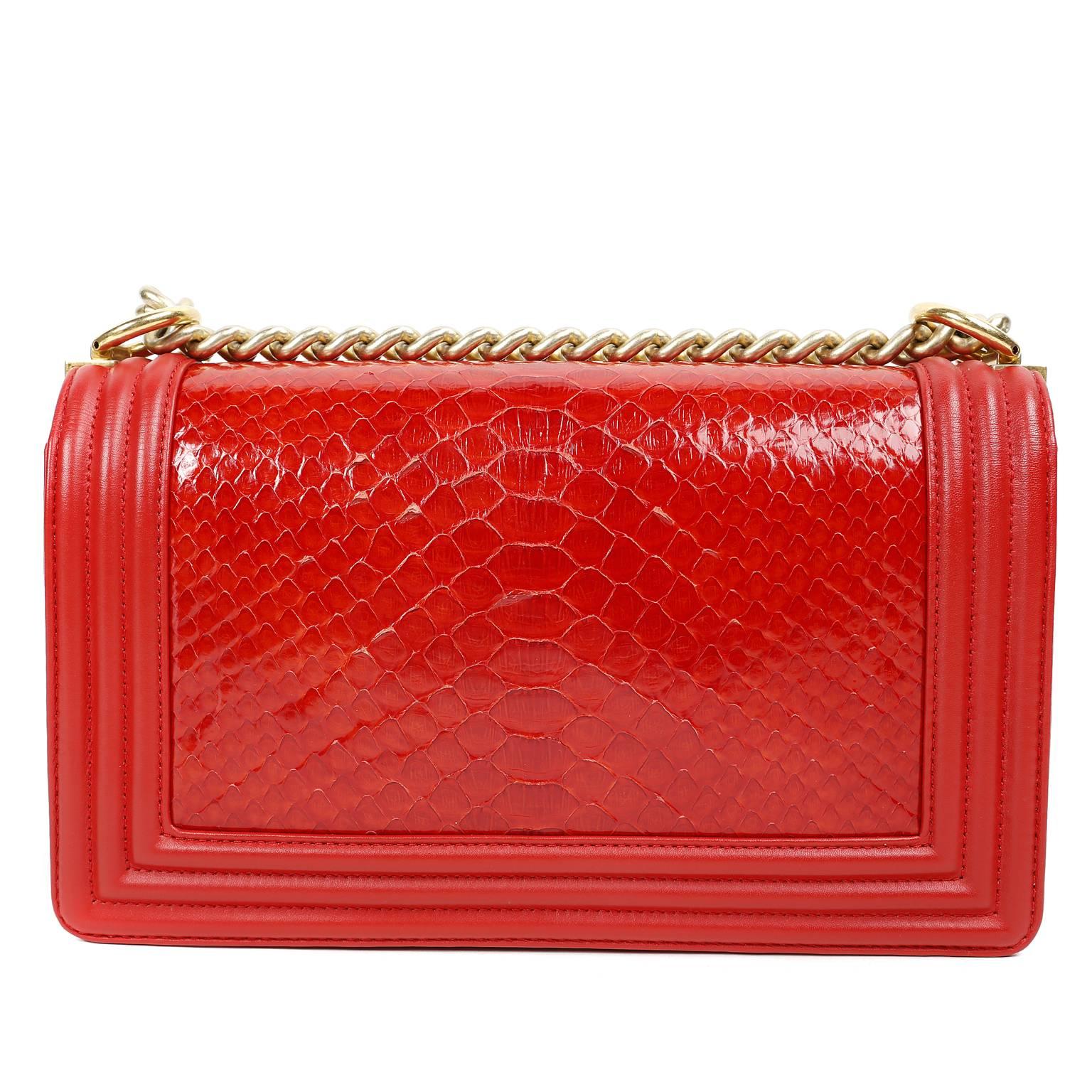 Chanel Red Python Medium Boy Bag- PRISTINE; Never Carried
 The updated style is breathtaking in this mesmerizing combination of exotic skin, leather and antiqued gold hardware.
 
Lipstick red python skin is framed in red welted leather trim,