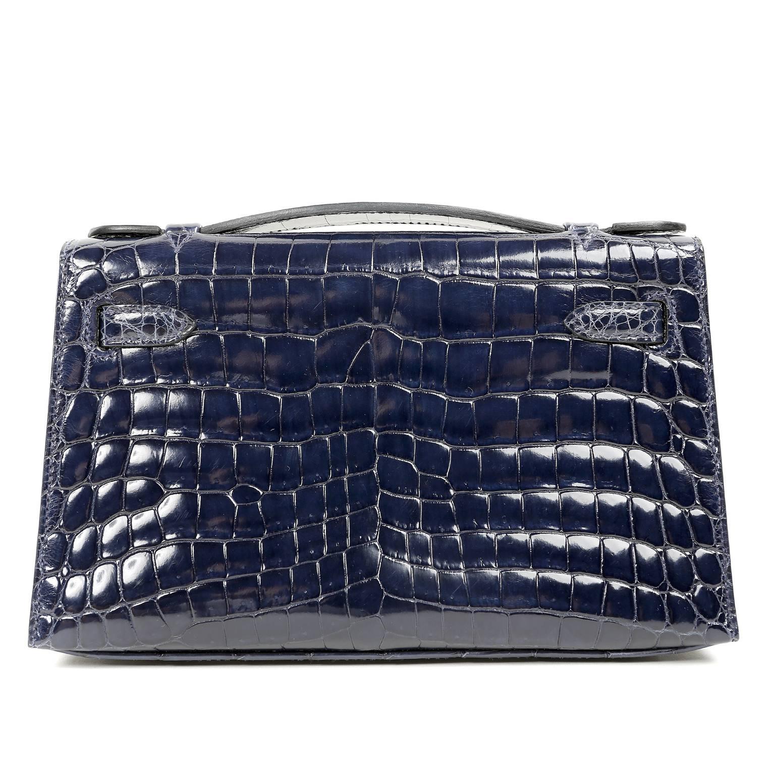 Hermès Blue Marine Niloticus Crocodile Kelly Pochette- NEW; NEver Carried  The protective plastic remains intact on the hardware. 
 Hermès bags are considered the ultimate luxury item worldwide.  Each piece is handcrafted with waitlists that can