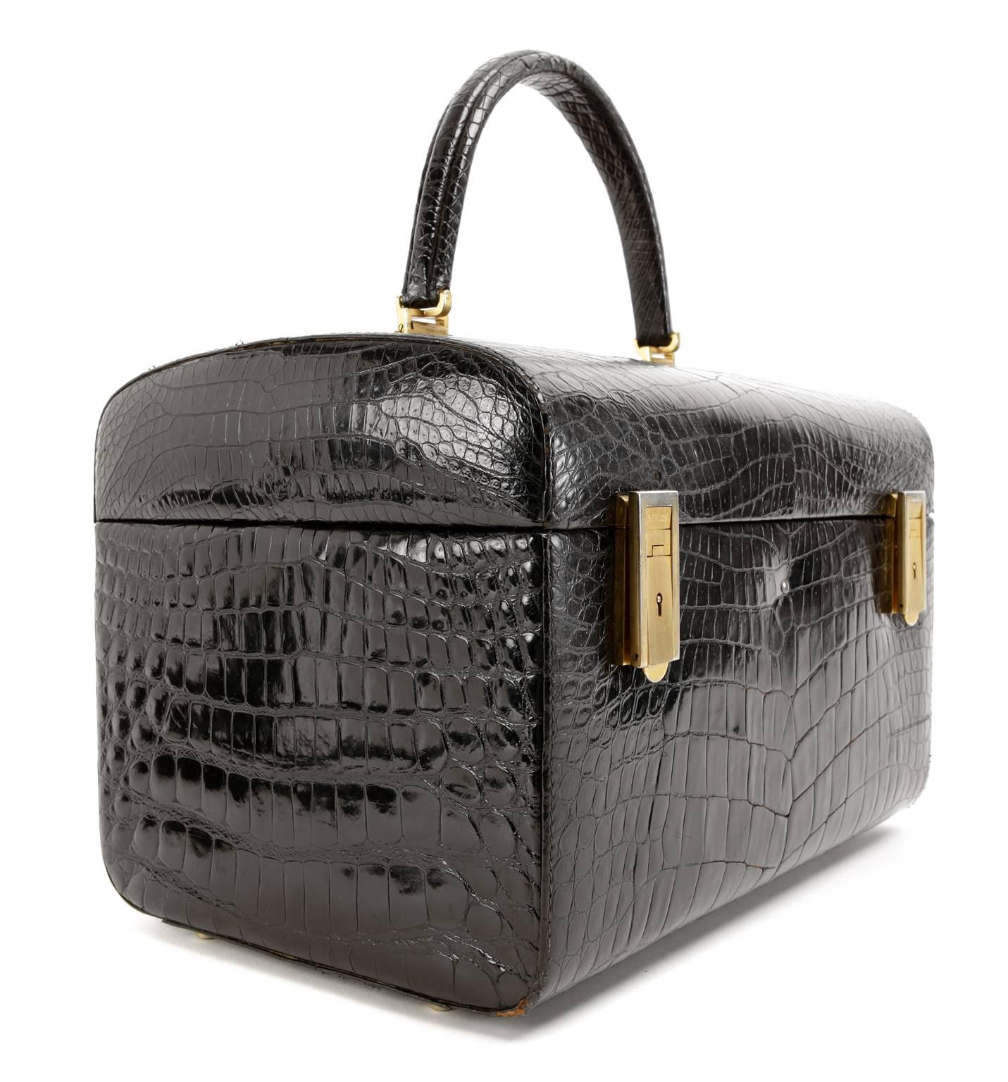 Revlon Black Crocodile Custom Cosmetics Case- EXCELLENT
Very rare, this totally unique piece is a must have for collectors. 
 
Black crocodile case has double clasp opening in matte gold tone hardware.  The top of the case opens to reveal a