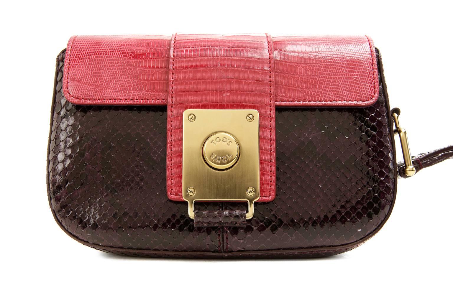Tod’s Purple Python and Red Lizard Wristlet- PRISTINE;  appears never carried
 A fantastic find for exotic lovers, this petite piece combines python and lizard skin in of- the-moment color blocked fashion. 
 
Deep purple python base has a red