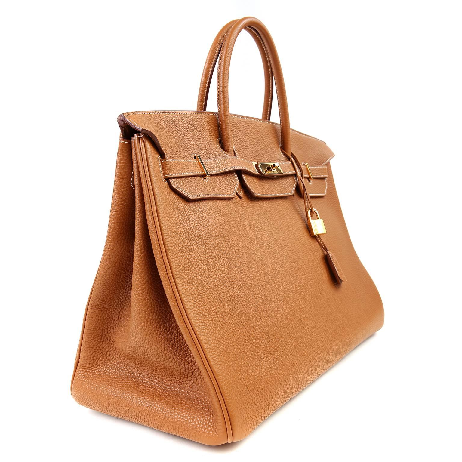 Hermès Gold 40 cm  Togo Birkin Bag is pristine. The coveted classic color is a must have neutral and remains on many wish lists.   Entirely crafted by hand, the Hermès Birkin is possibly the most sought after handbag worldwide.  
 
  Scratch