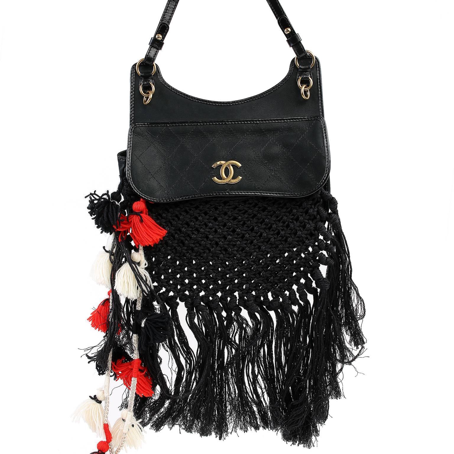 Chanel Black Bohemian Runway Bag- PRISTINE
  Free spirit accents cover this fabulous and collectible cross body.  

Black leather slim messenger silhouette has black crocheted bottom.  Red, black, white and ecru tassels dangle decoratively from