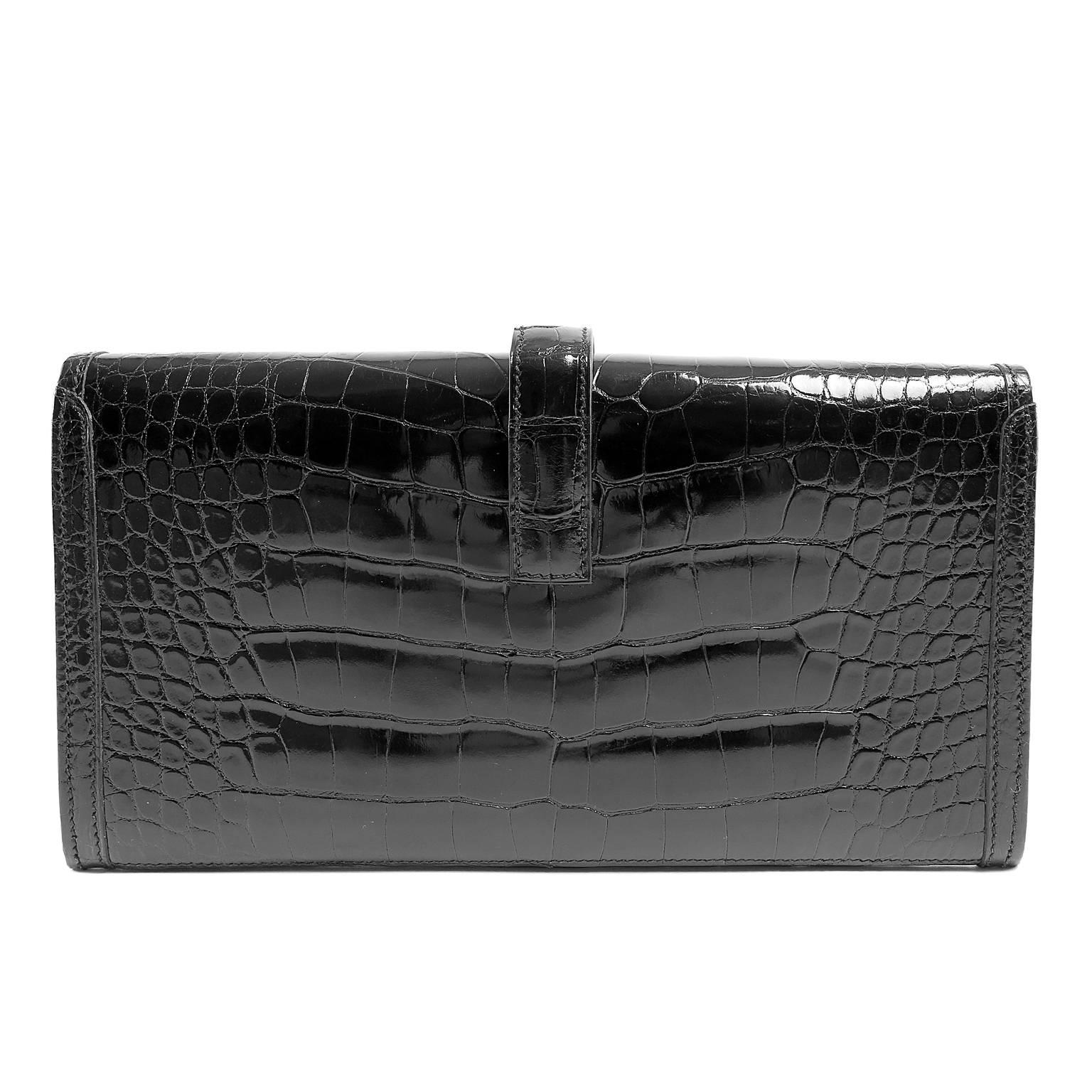 Hermès Black Alligator Jige Clutch- PRISTINE;  appears never carried.  Considered highly collectible, an exotic Hermès bag is very rare.  The highest quality skins are used to make each piece by hand.  Exotics are naturally more expensive than