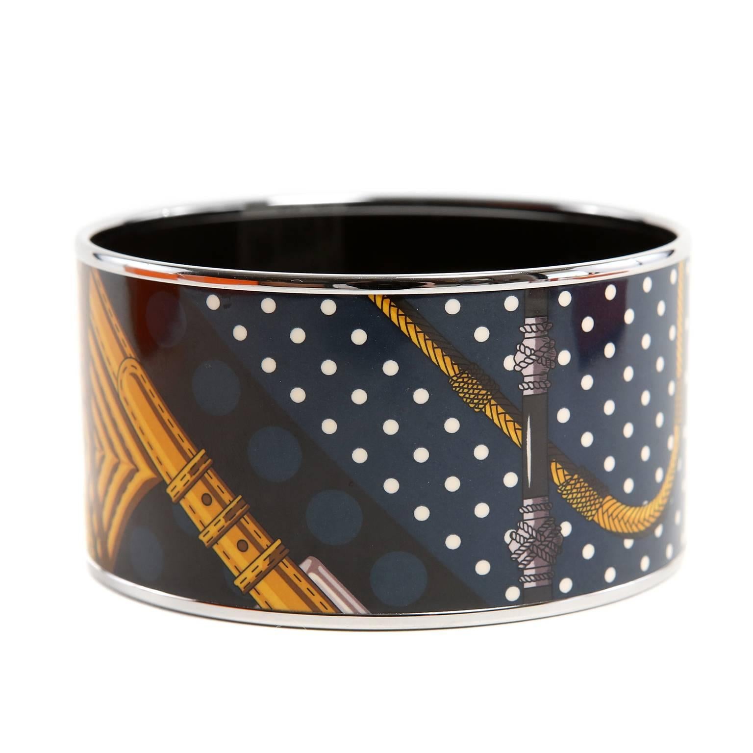 Hermès Black Enamel XL Cuff Bracelet- PRISTINE
  The extra large bangle can be worn with everything from jeans to gowns. 
 
  Equestrian themed- black enamel with navy, white dots and gold rope design.  Made in France. Q stamp.     
HB5, HB9