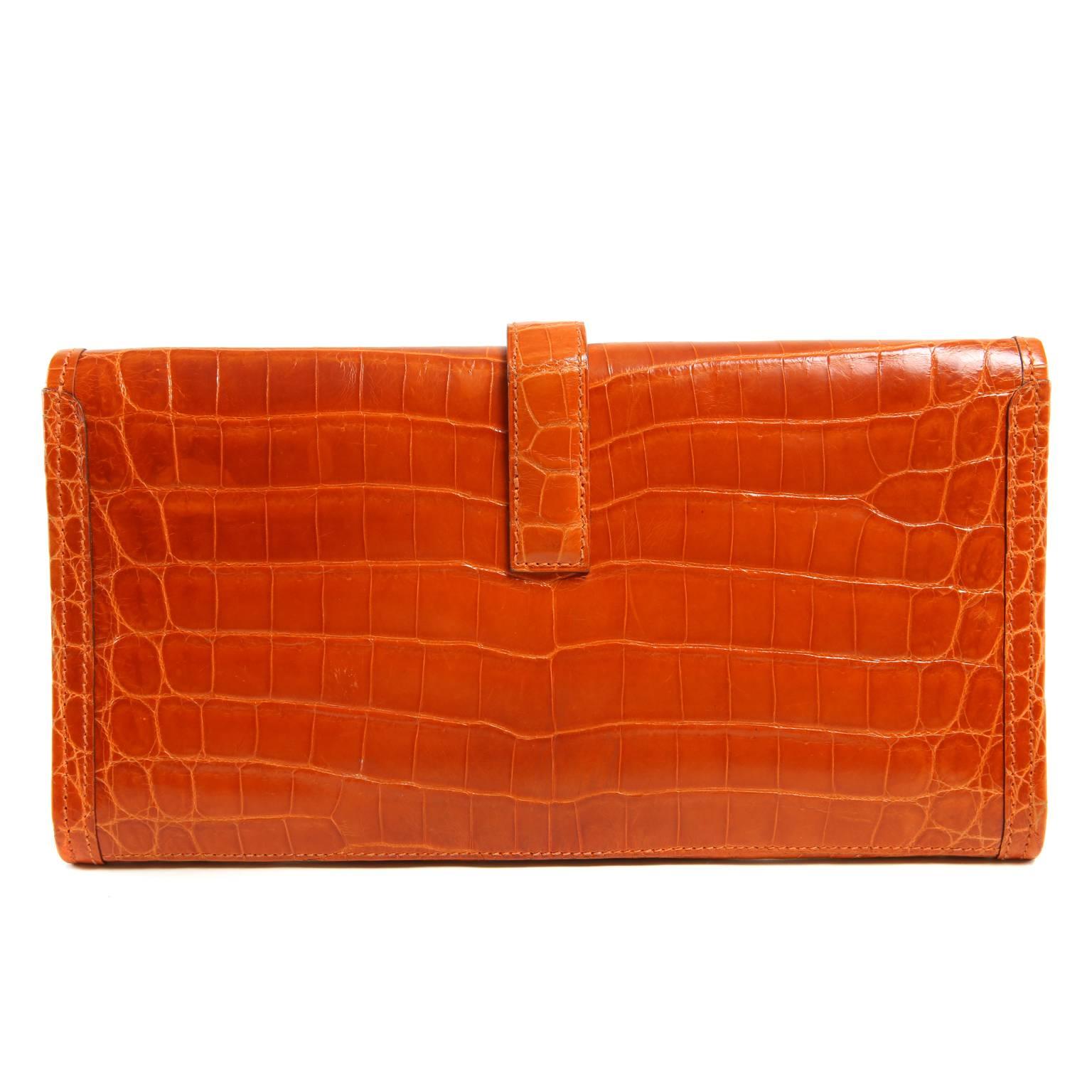 Hermès Orange Niloticus Crocodile Jige Clutch- PRISTINE
  Extremely collectible, exotic Hermès pieces are very rare.  The highest quality skins are used to make each piece by hand.  Exotics are naturally more expensive than bovine pieces.
