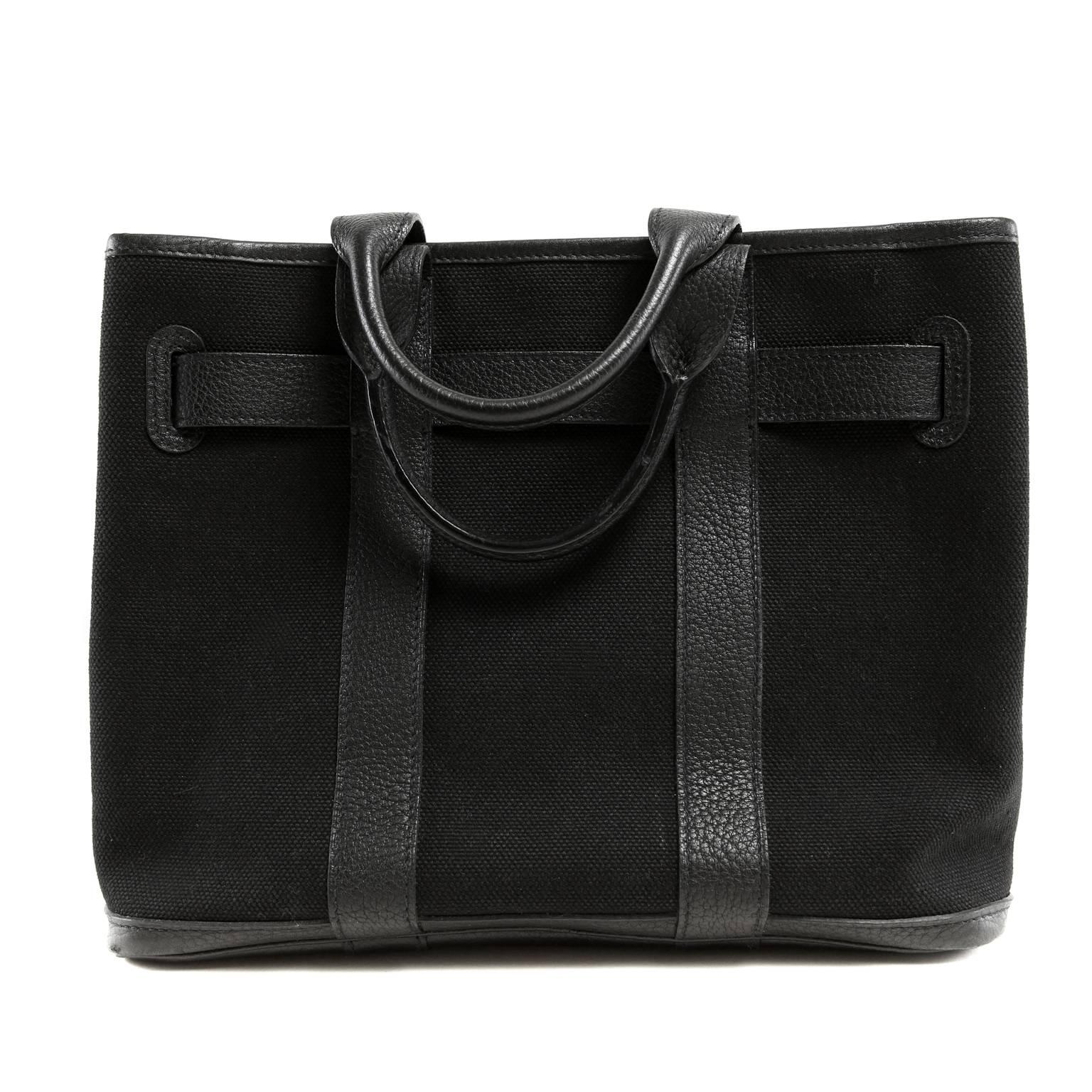 Hermès Black Petit Ceinture PM Tote- PRISTINE; appears never carried

  The canvas and leather “belt” bag has an ample twelve inch width and is suitable for both men and women. 
  
Black durable canvas is trimmed with coordinating Togo leather,