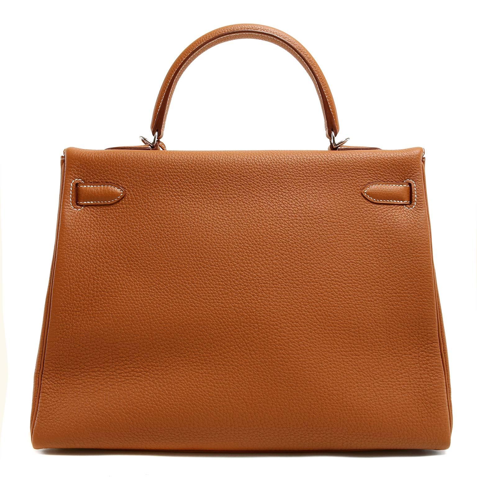 Hermès Gold Togo 35 cm Kelly- PRISTINE unworn condition.  The protective plastic remains intact on the hardware.   Hermès bags are considered the ultimate luxury item worldwide.  Each piece is handcrafted with waitlists that can exceed a year or