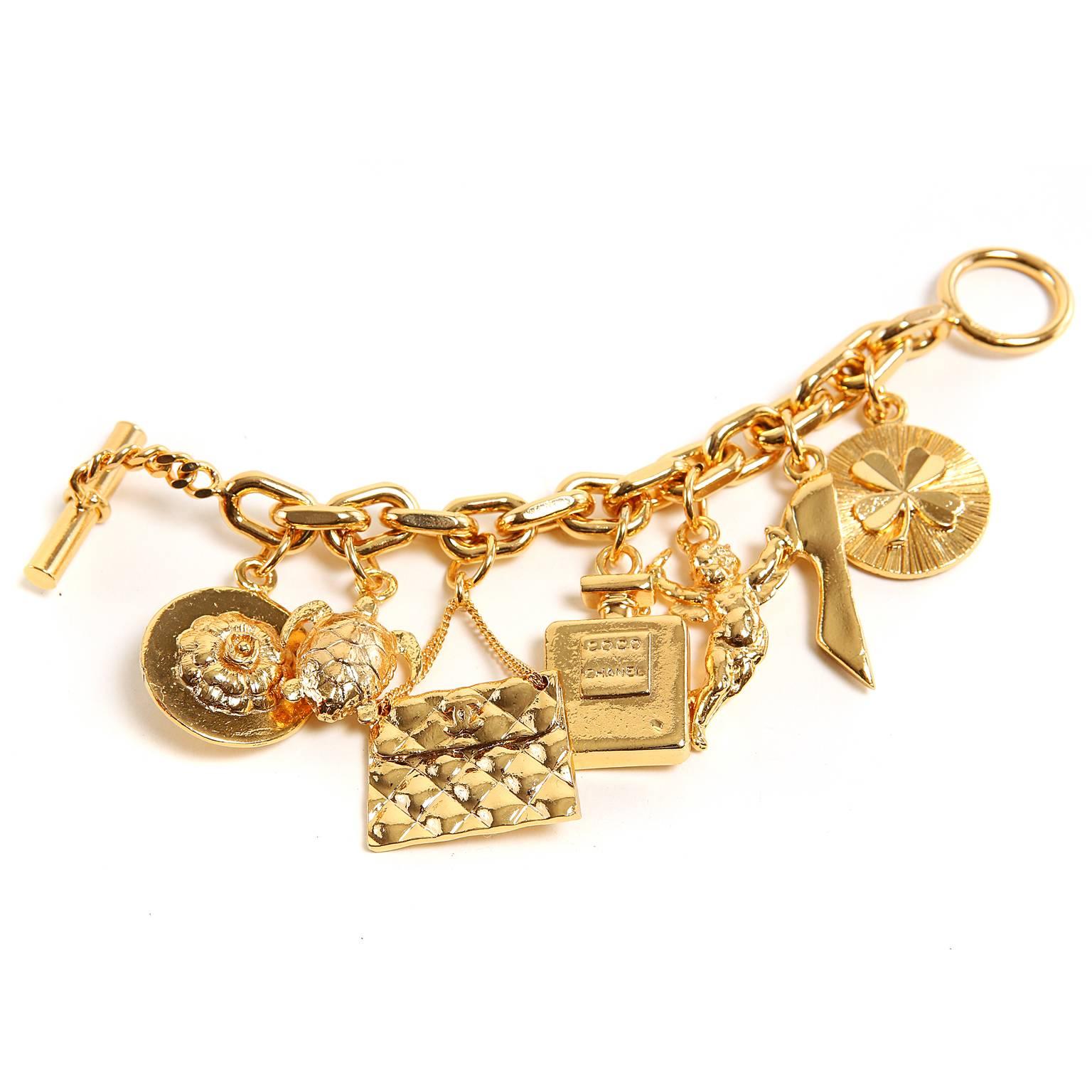 Chanel Vintage Gold Charm Bracelet is an amazing find in excellent plus condition.  The perfect gift for the Chanel lover in your life (even yourself). 
 
Gold tone link bracelet has seven dangling Chanel iconic charms:  purse, shoe, turtle,