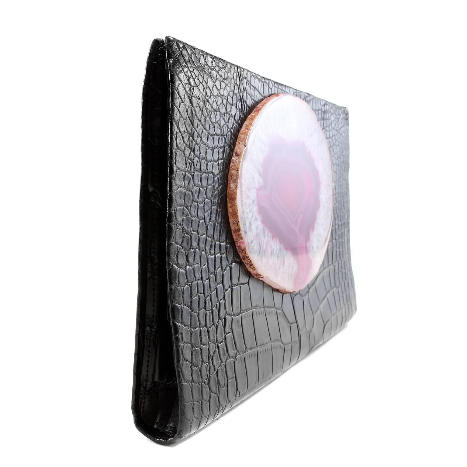 Paige Gamble Black Alligator Clutch- PRISTINE
Totally unique and very rare, this eye-catching collectible combines brilliant color and textures.
 
Slim black alligator skin clutch is adorned with a large slice of rare fuchsia agate quartz. 