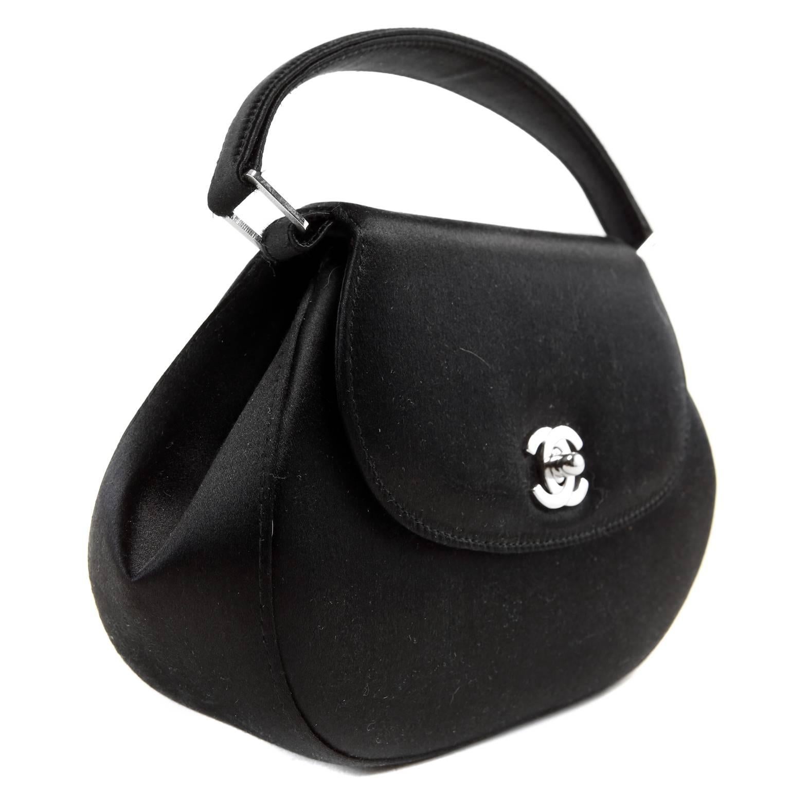 hanel Black Satin Oval Evening Bag- Pristine
 Elegant and timeless, this classic piece is smart addition to any sophisticated collection. 
 
Black satin small bag has a softly rounded silhouette.  Silver interlocking CC secures the front flap. 