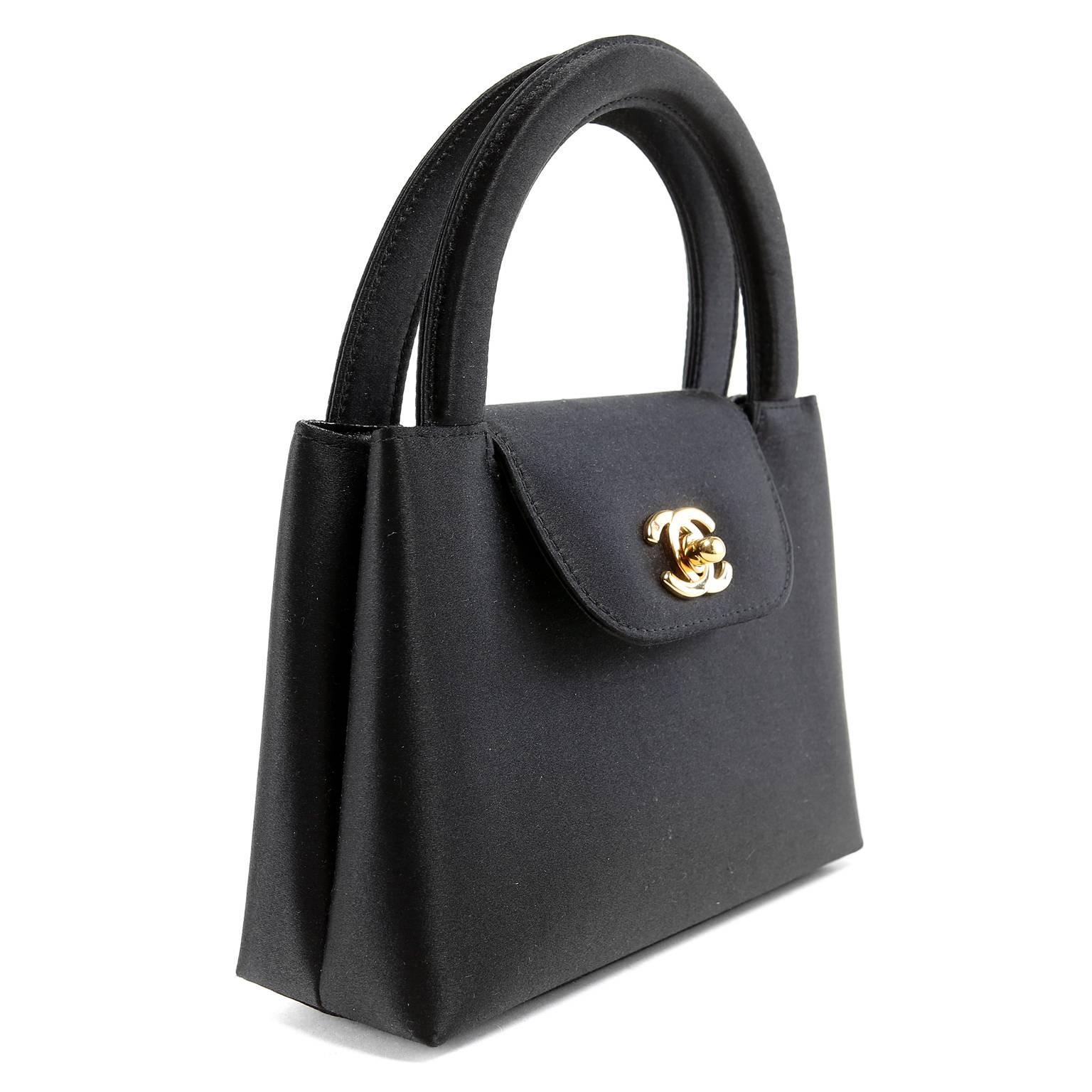 hanel Black Satin Evening Bag is in pristine condition.  Ladylike and refined, the sophisticated small bag is certain to be a go to piece for many years.
 
Black satin small bag has gold interlocking CC twist lock on front flap.  Black leather