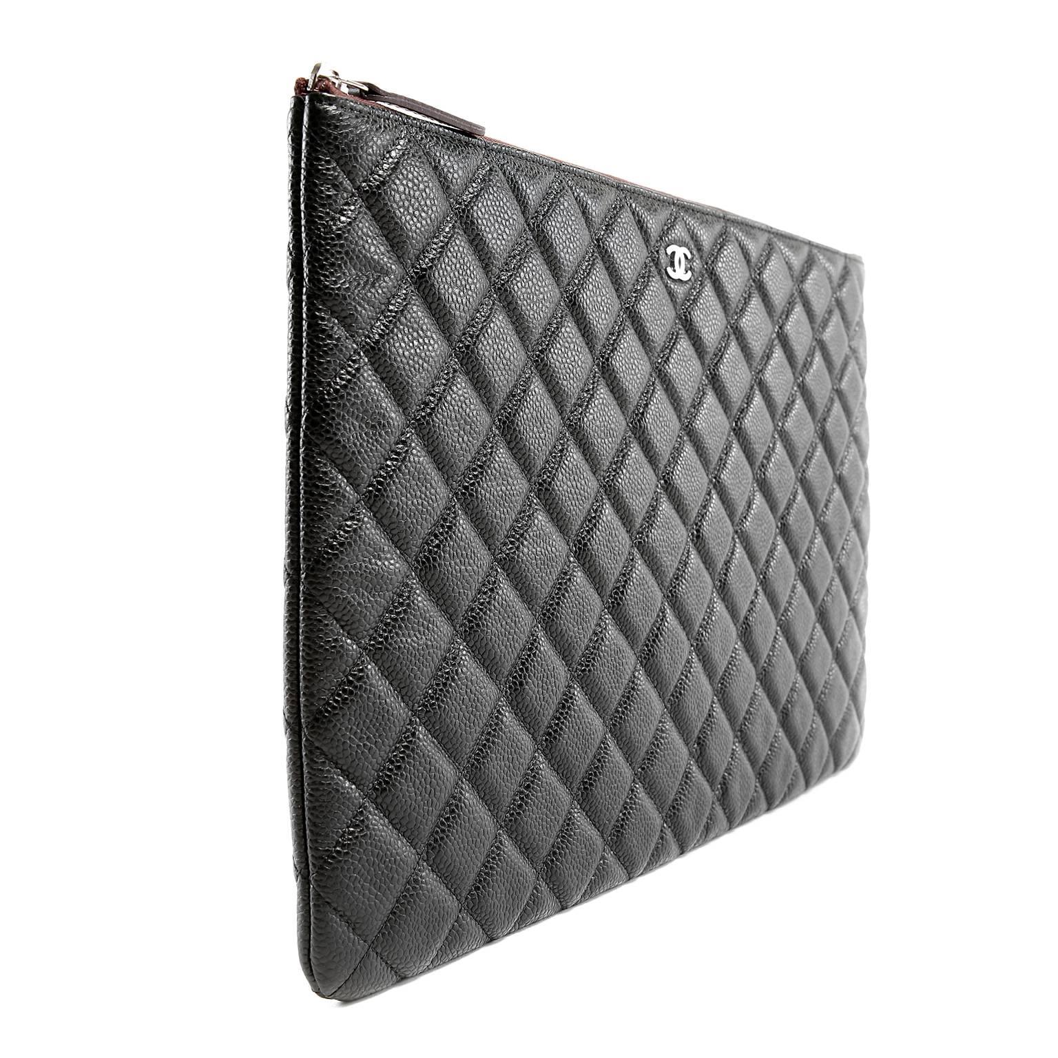 Chanel Black Caviar Leather Portfolio is pristine. A stylish carryall for folders or tossed inside a larger bag, this is a smart unisex item.
 
Durable and textured black caviar leather is quilted in signature Chanel diamond stitched pattern.  The