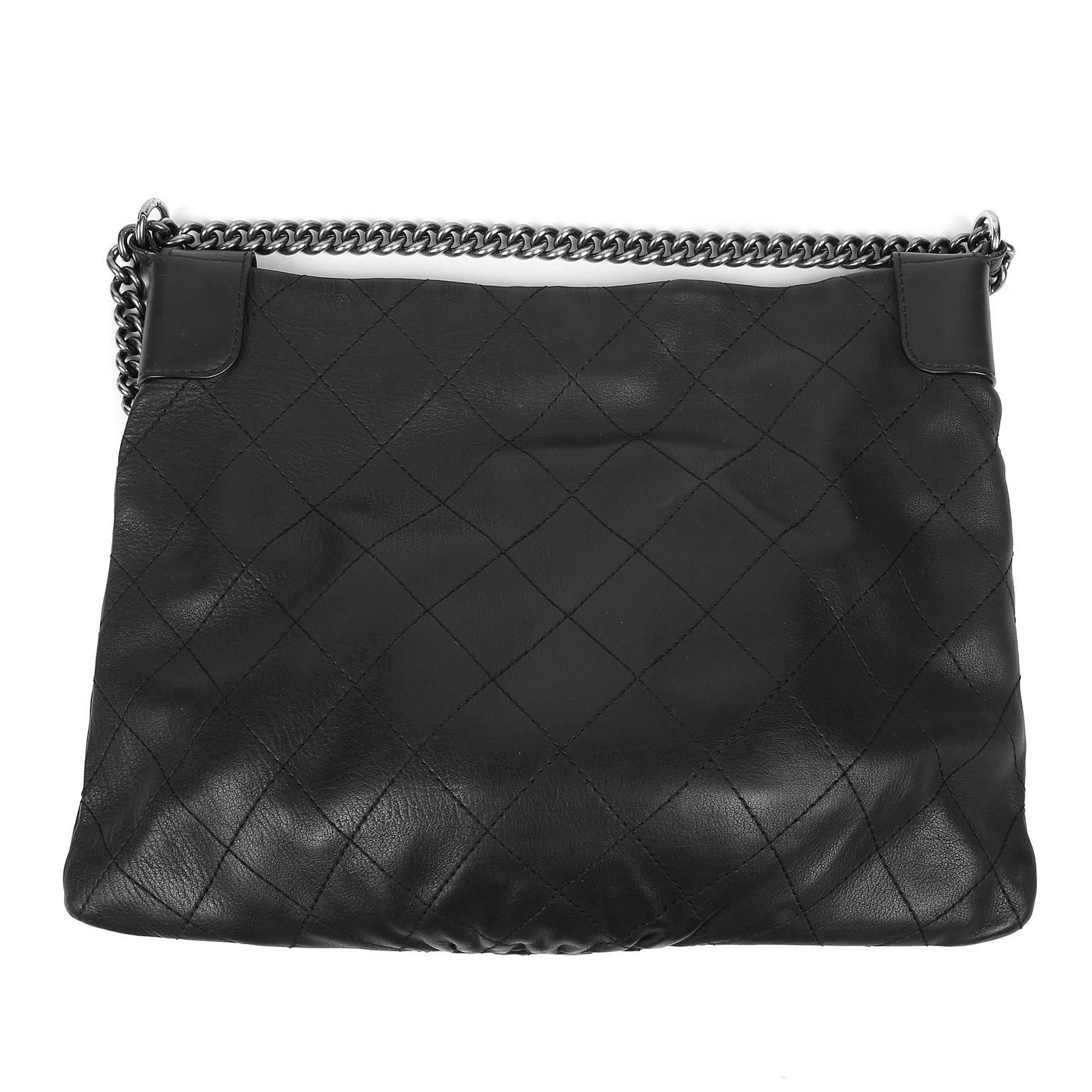 This Authentic Chanel Black Deerskin Tote is in pristine condition.   Roomy yet slim to the body, it easily carries all the essentials in style.

 Soft black deerskin is stitched in signature Chanel diamond pattern with edgy ruthenium hardware