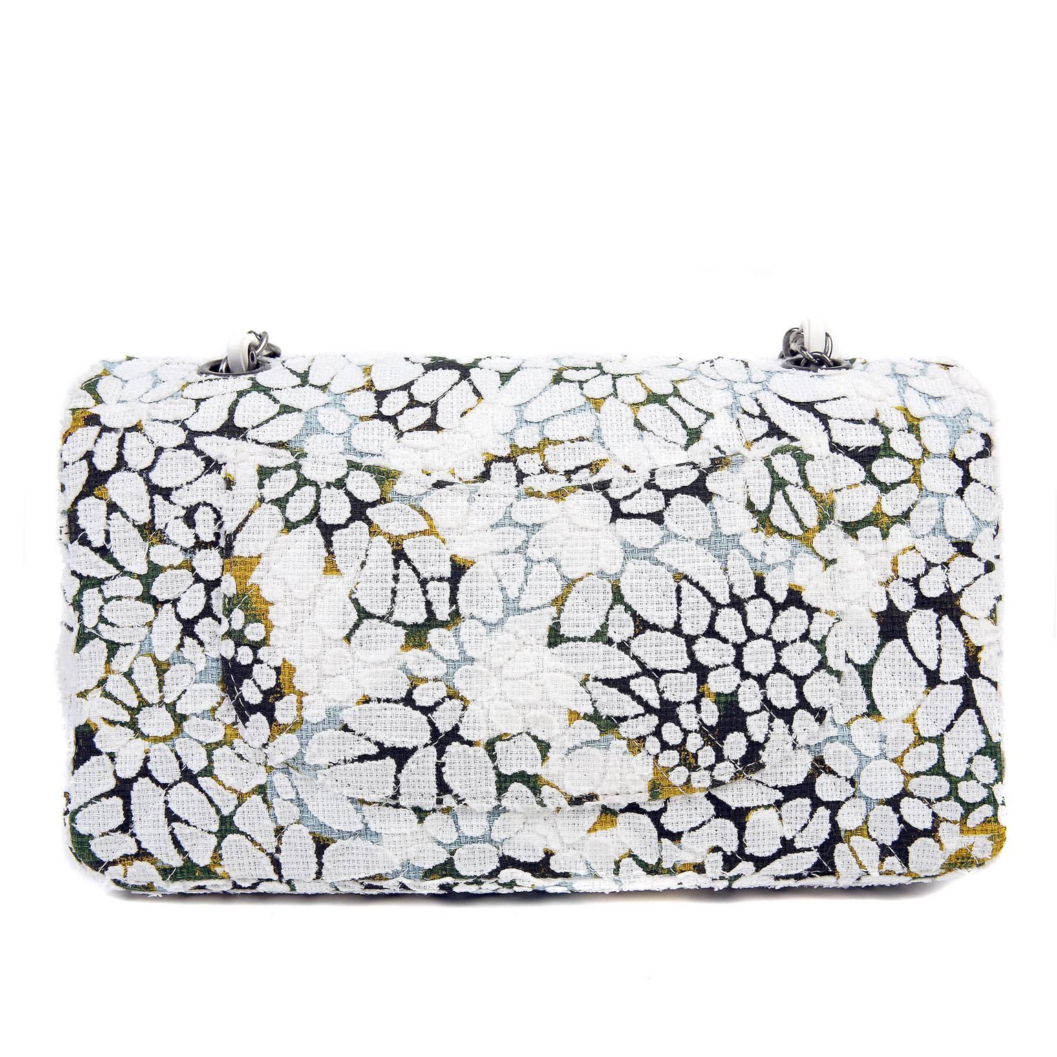 This Authentic Chanel Floral Tweed Classic Flap is in pristine condition.  A stunning collectible from the Spring Summer 2015 Collection, this whimsical piece is perfect for any wardrobe.

Medium sized double flap is covered in white laser cut