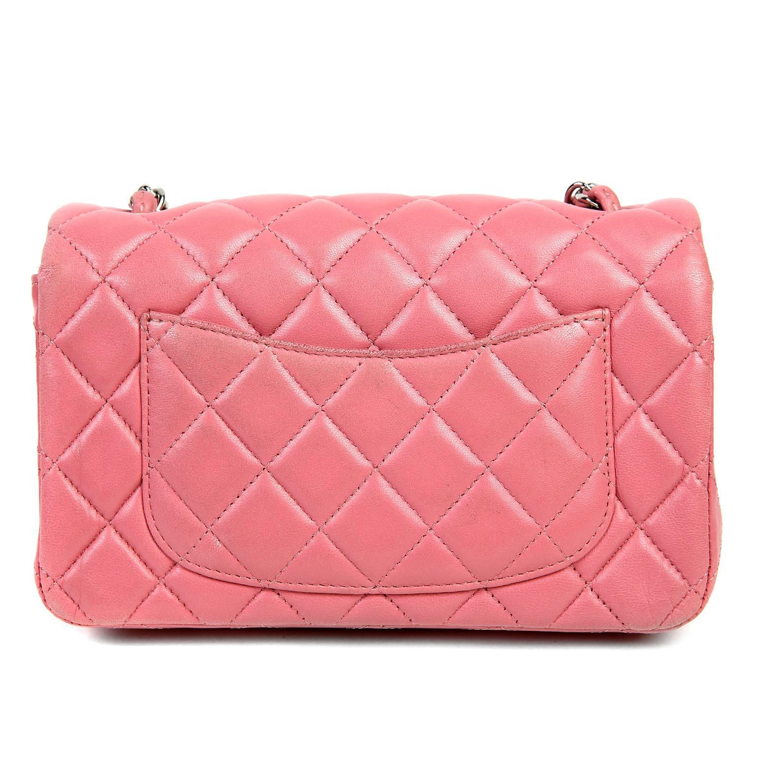 This Authentic Chanel Pink Lambskin Mini Classic is in better than excellent condition.  The pretty pink shade adds an extra dash of femininity to any ensemble. 

 Carnation pink lambskin is quilted in signature Chanel diamond stitched pattern. 