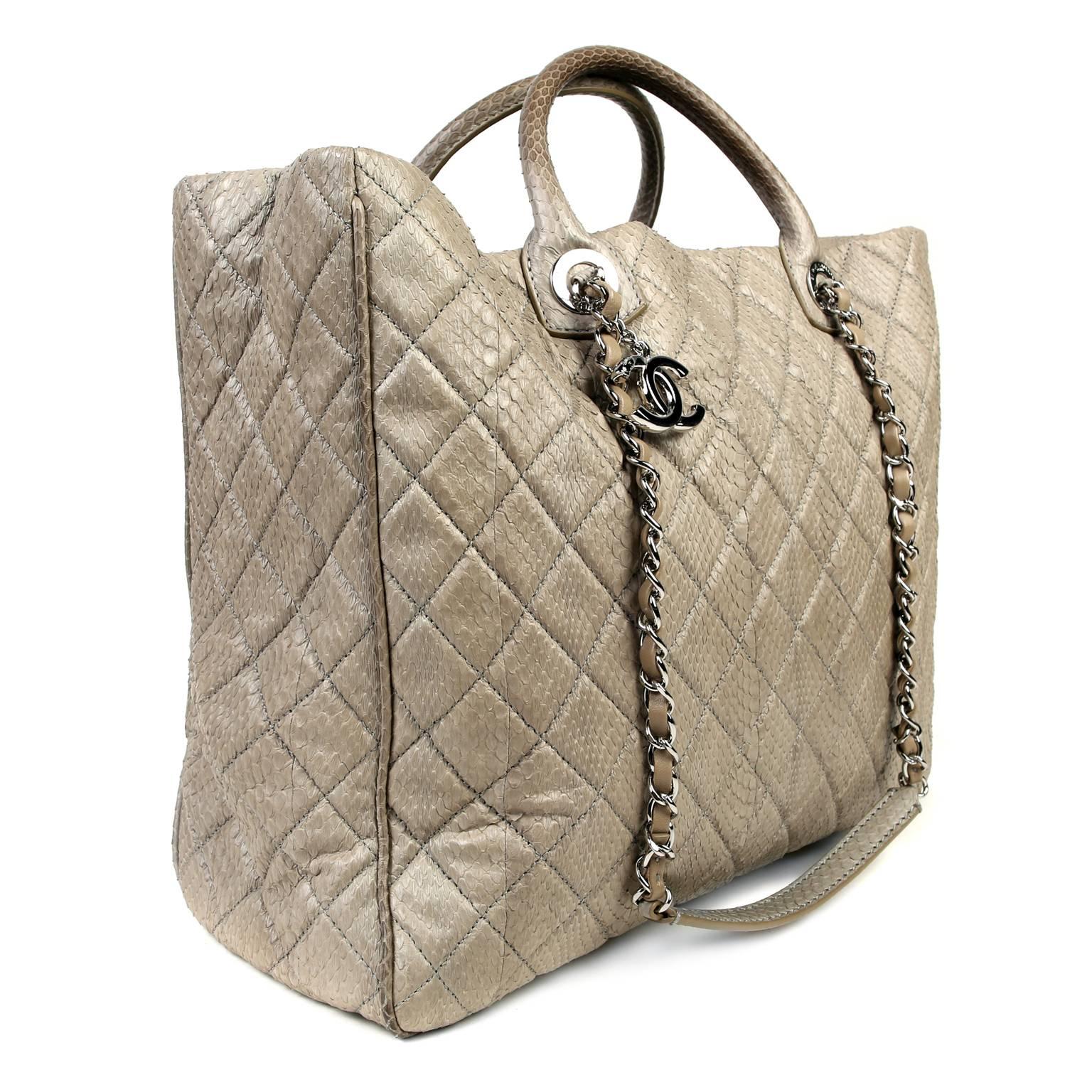 This Authentic Chanel Taupe Python Shopper is in pristine unworn condition.  A stunning exotic, the classic silhouette is certain to hold its value while becoming a treasured favorite. 

Taupe python skin is quilted in signature Chanel diamond