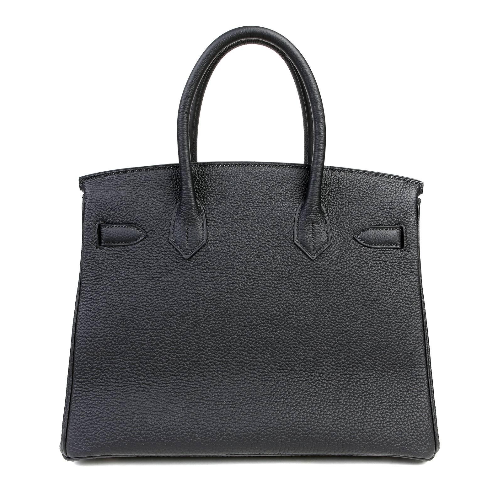 This Authentic Hermès 30 cm Black Togo Birkin Bag is in pristine unworn condition with the plastic intact on the hardware.  Waitlists exceeding a year are commonplace for the intensely coveted classic Black leather Birkin. Each piece is hand