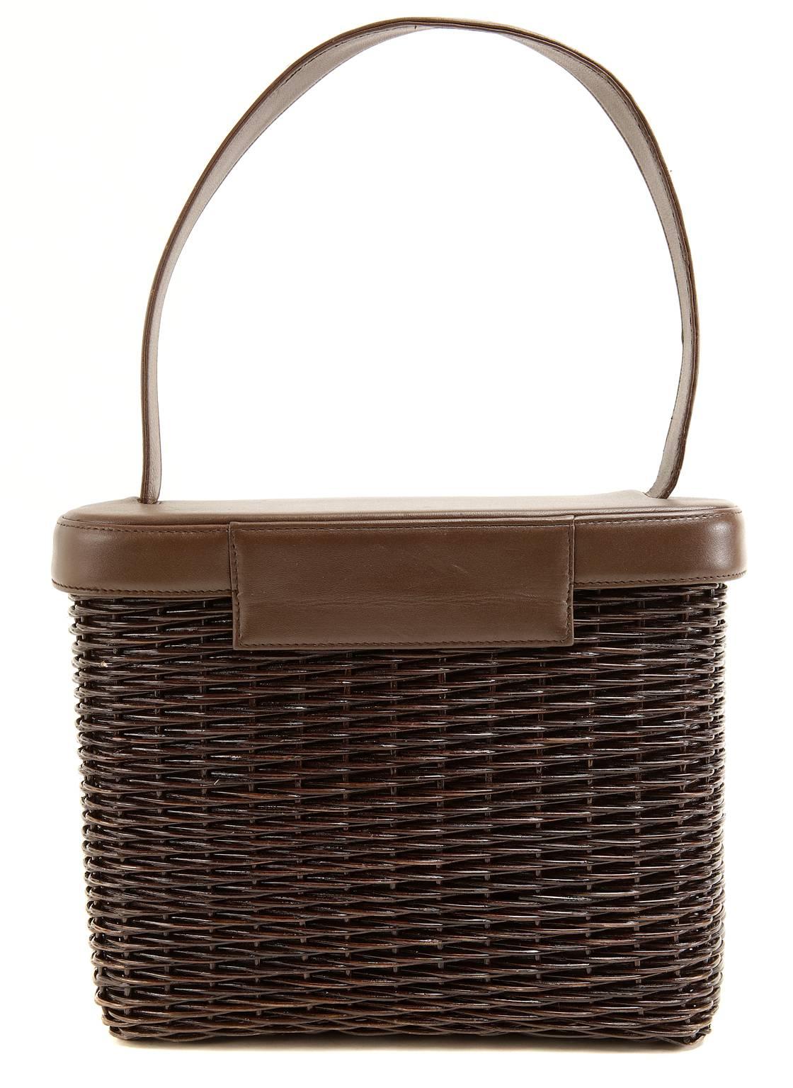 Chanel Brown Wicker Picnic Bag is in pristine condition.  The rarely seen style is a must have for collectors. 
 
Dark brown woven wicker is combined with milk chocolate leather in this whimsically styled purse constructed like a picnic basket. 