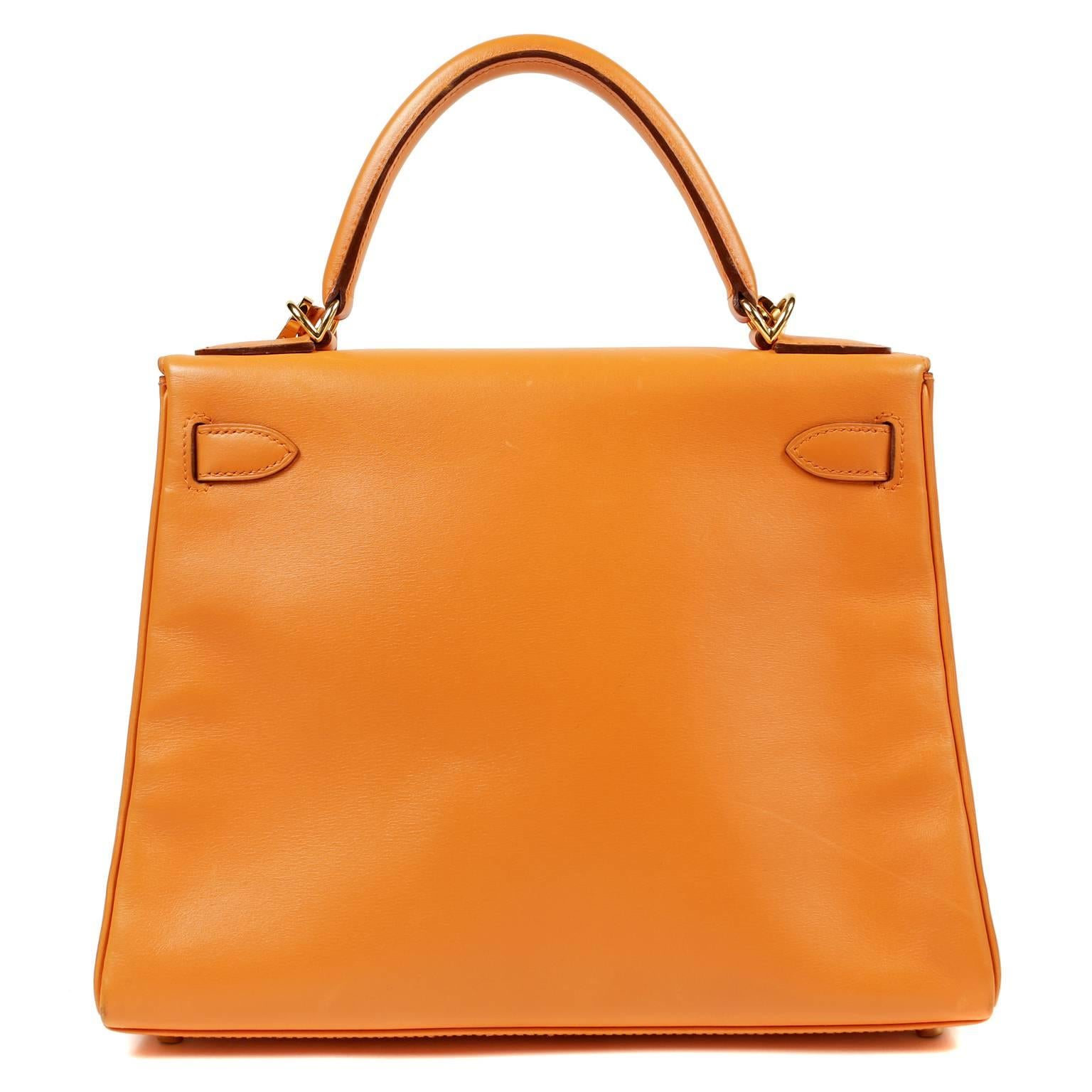 Hermès  Orange Box Calf 28 cm Kelly- Nearly Pristine with slight signs of prior ownership.
  Hermès bags are considered the ultimate luxury item worldwide.  Each piece is handcrafted with waitlists that can exceed a year or more.  The streamlined