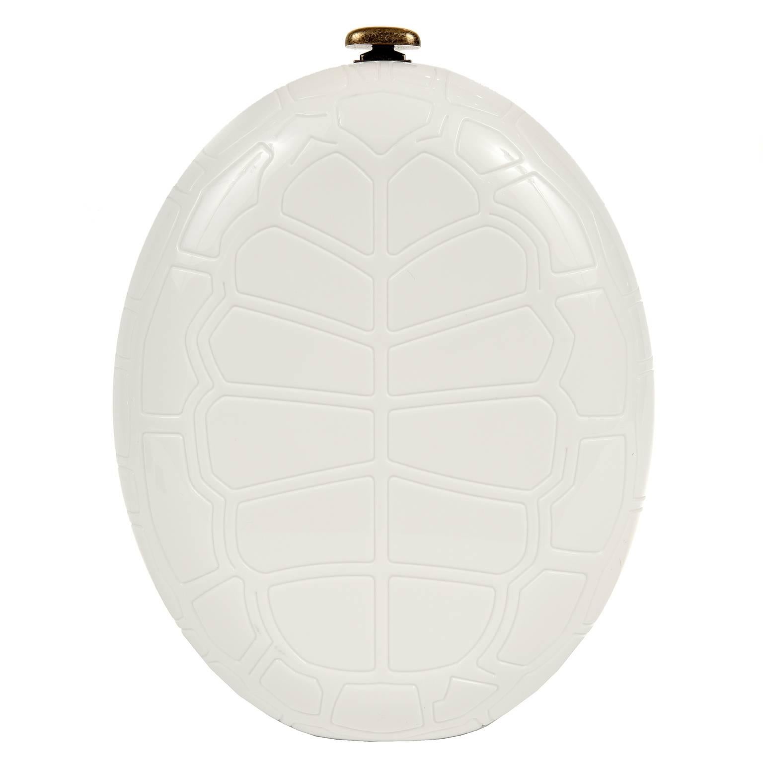 Chanel Ivory Turtle Shell Print Bag is from the 2016 Cruise Collection.  It is pristine.  
Ivory resin oval is imprinted with turtle shell pattern.  Antiqued gold hardware accents and extra- long chain strap.  Press lock clasp accesses the beige
