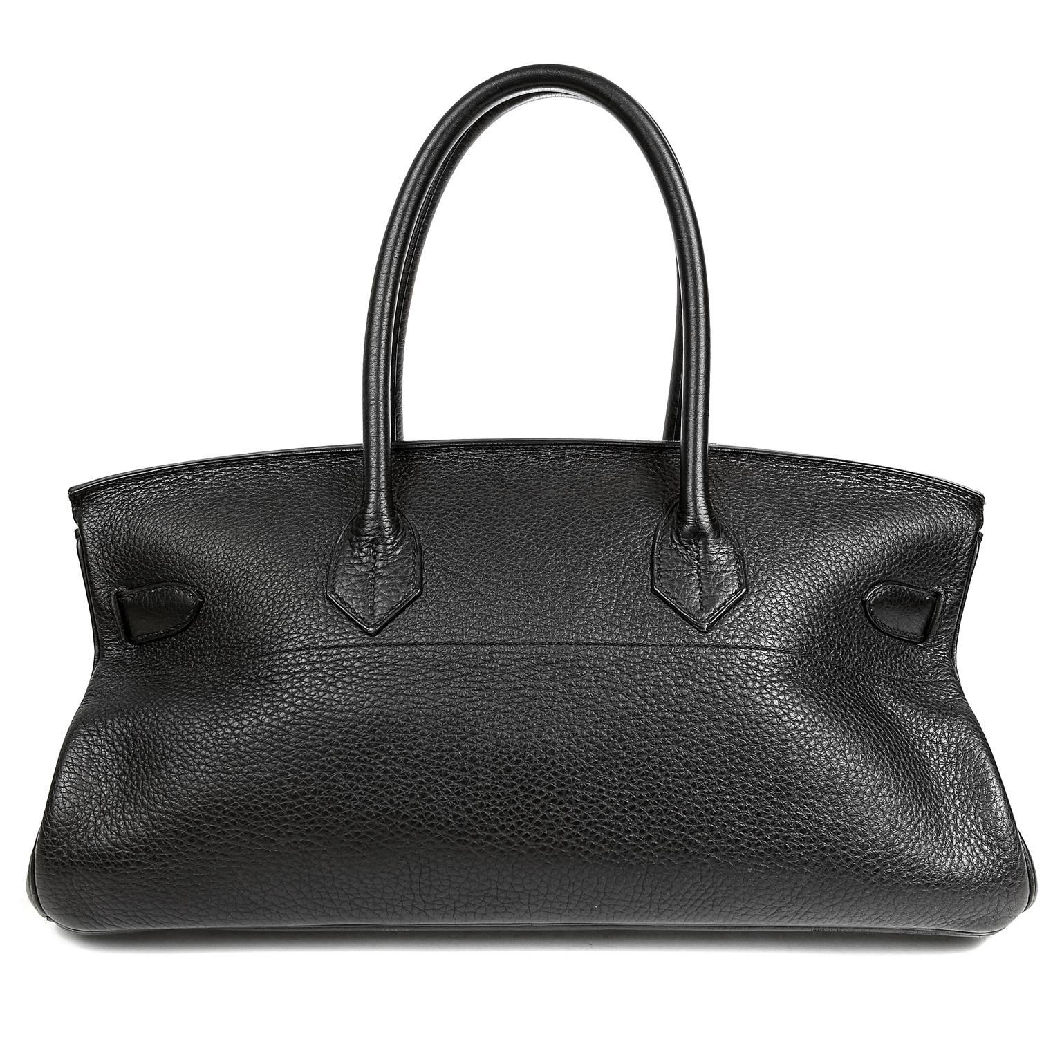 This authentic Hermès Black Togo Leather JPG Birkin is in excellent plus condition.  Designed by Jean Paul Gaultier, the wider and shorter version of the classic Birkin is highly collectible.  Handcrafted by skilled artisans, waitlists for Birkins