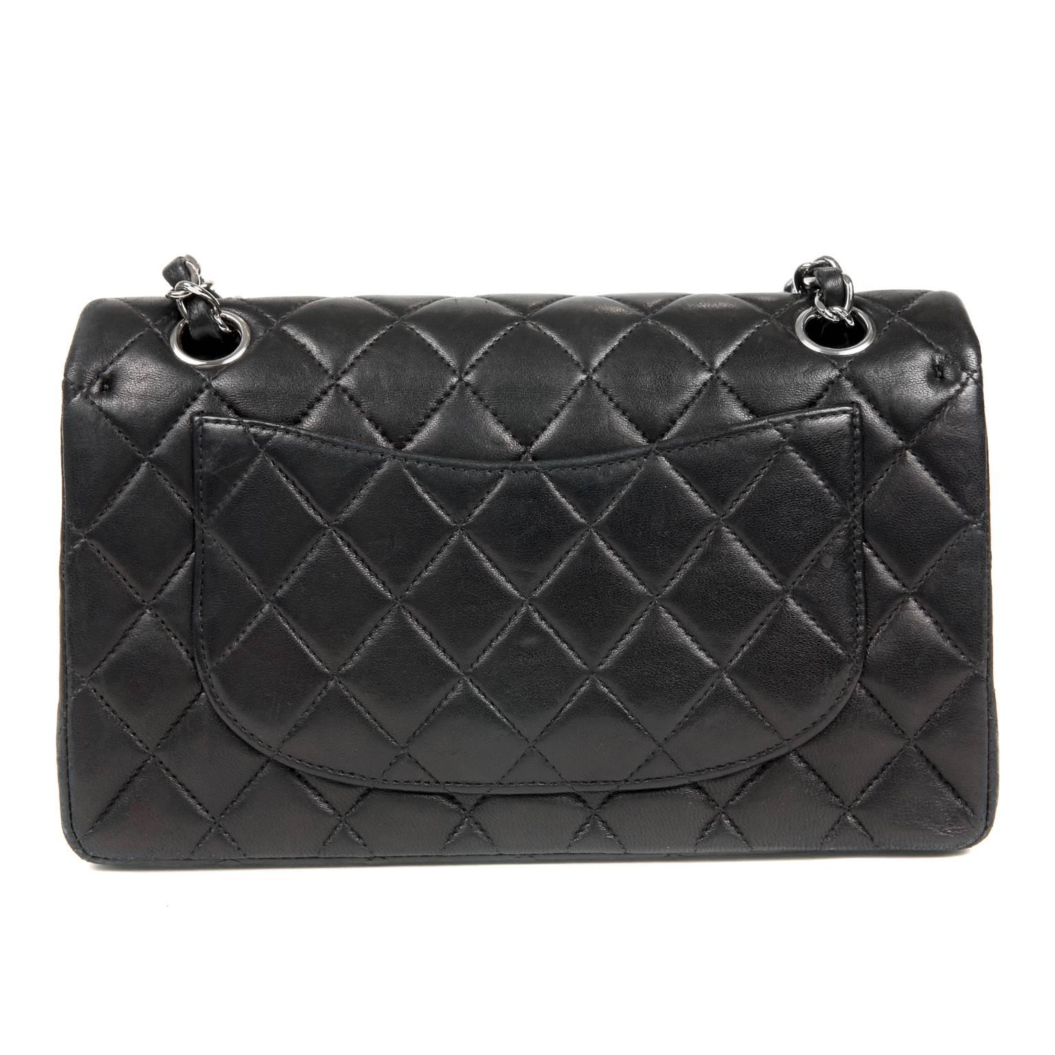 Chanel Black Lambskin Classic- Near Pristine
  Perfectly scaled in the medium silhouette, it can be carried for any occasion. 

Black lambskin is quilted in signature Chanel diamond pattern.  Silver interlocking CC twist lock secures the exterior