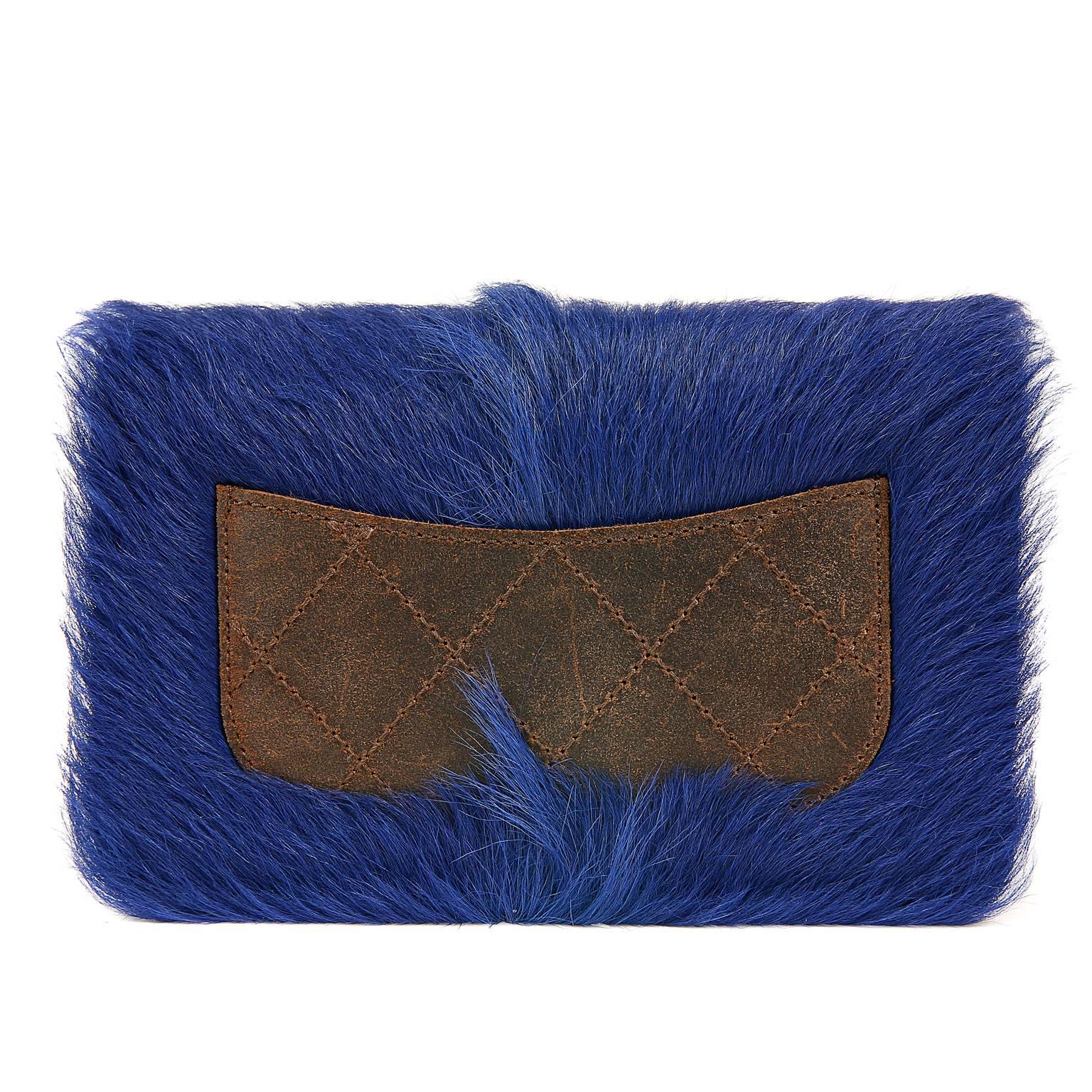 Chanel Blue Fur Wallet on a Chain- PRISTINE
  From the 2013 Paris- Edinburgh Runway collection, this stand out piece is a must have for collectors.

Nearly neon blue goat fur combines beautifully with distressed brown leather which surrounds the