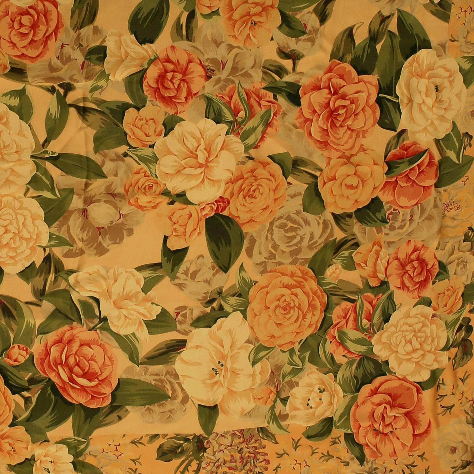 Chanel Silk Camellia Shawl is in pristine condition. 

The beautiful floral pattern has a vintage feel with soft muted colors.  Creamy yellow background with coral, peach, grey and white camellia floral design. 
A019