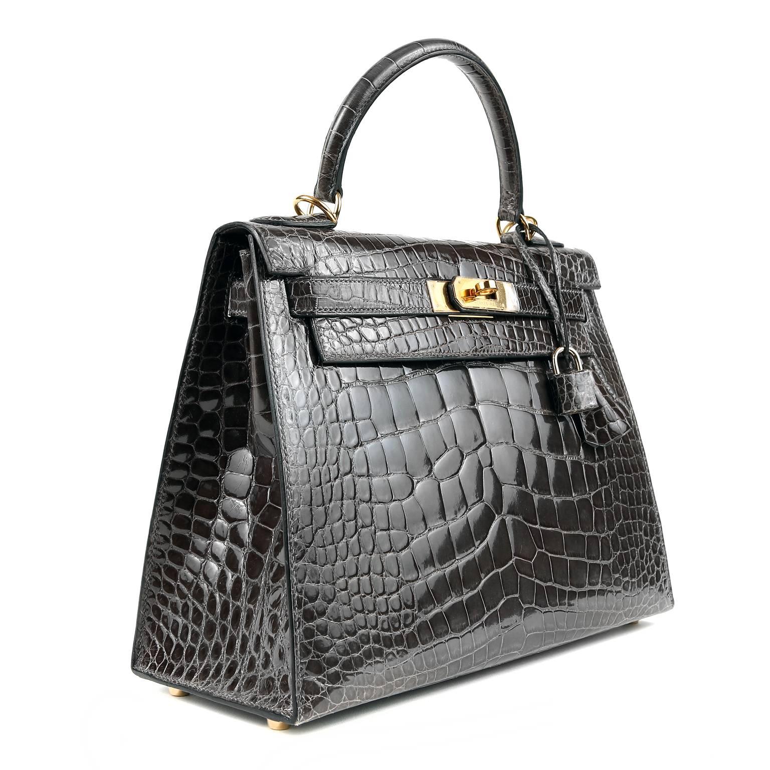 Hermès Graphite Alligator 28 cm Kelly Bag- Nearly Pristine   
Hermès bags are considered the ultimate luxury item the world over.  Hand stitched by skilled craftsmen, wait lists of a year or more are commonplace for the leather versions.  The