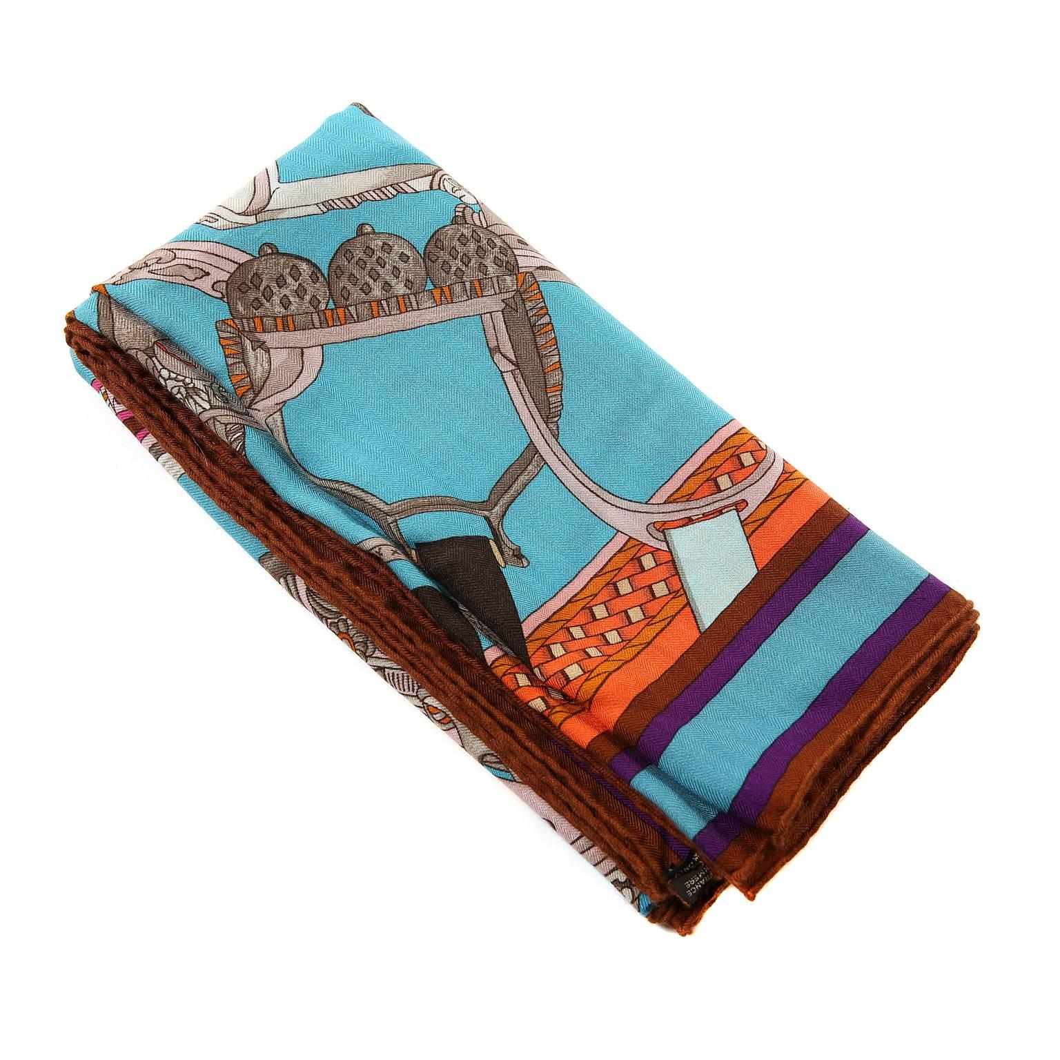 Hermès Turquoise Concours d’etriers Cashmere and Silk Shawl- Pristine
  The equestrian themed design features an array of antique stirrups, highlighting the intricate metalwork and exquisite details.       Turquoise background with orange, purple,