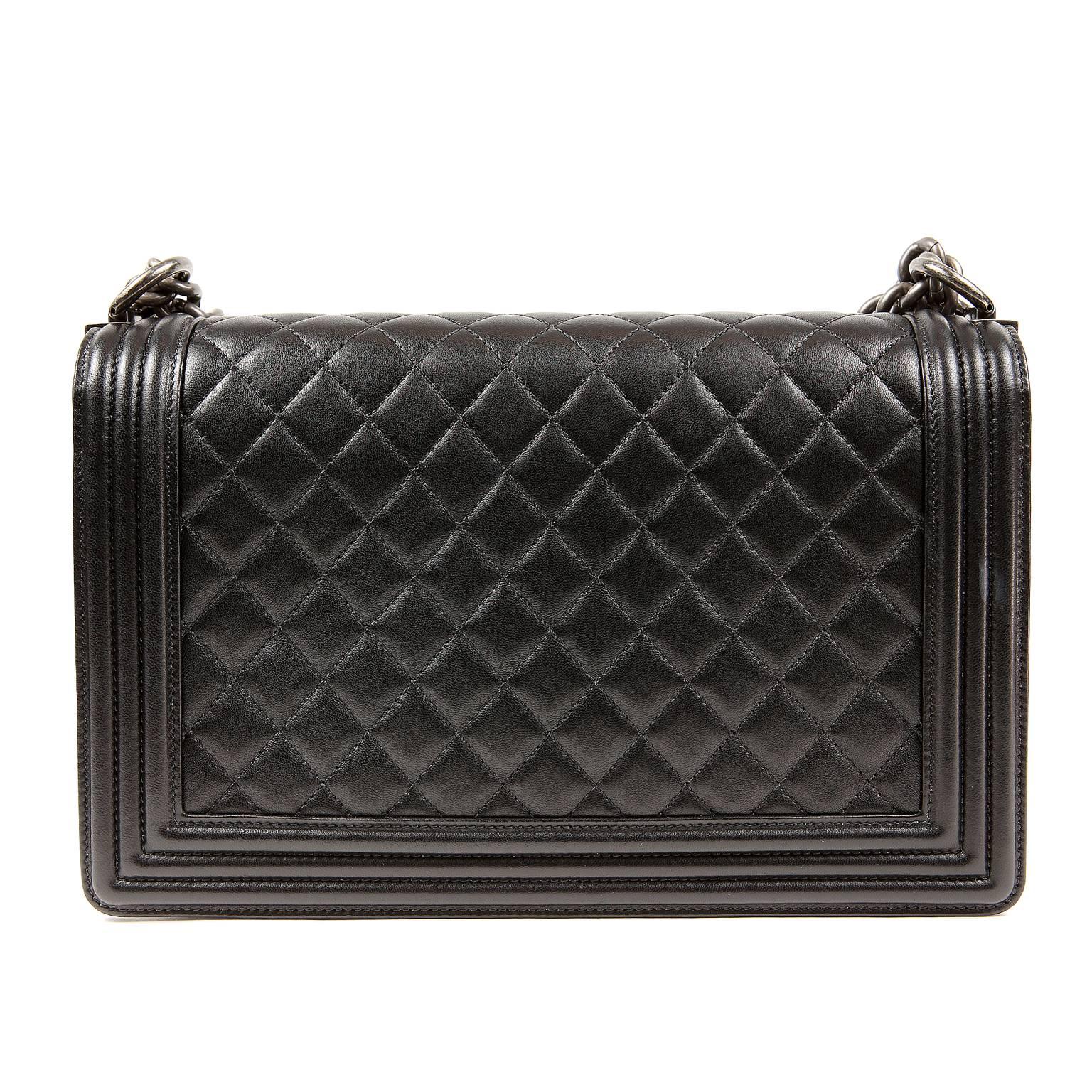 Chanel Black Lambskin Large Boy Bag- PRISTINE
 The updated design is structured and edgy with a versatility that makes it extremely popular.

Black lambskin is quilted in signature Chanel diamond stitched pattern with a welted framed edge.  