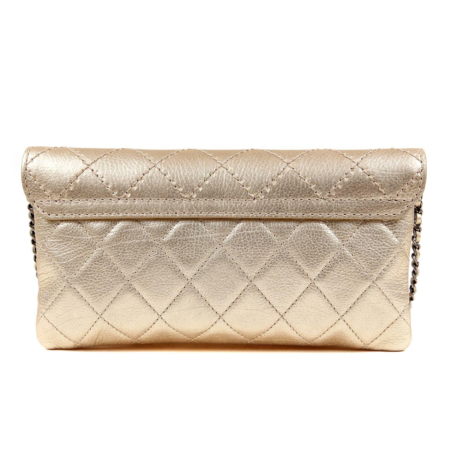 Chanel Gold Leather Cross Body Bag- PRISTINE, appearing never carried  Extremely versatile, this piece doubles as a clutch and combines metallics brilliantly. 
Soft metallic gold leather has a light pebbled texture and is further quilted in