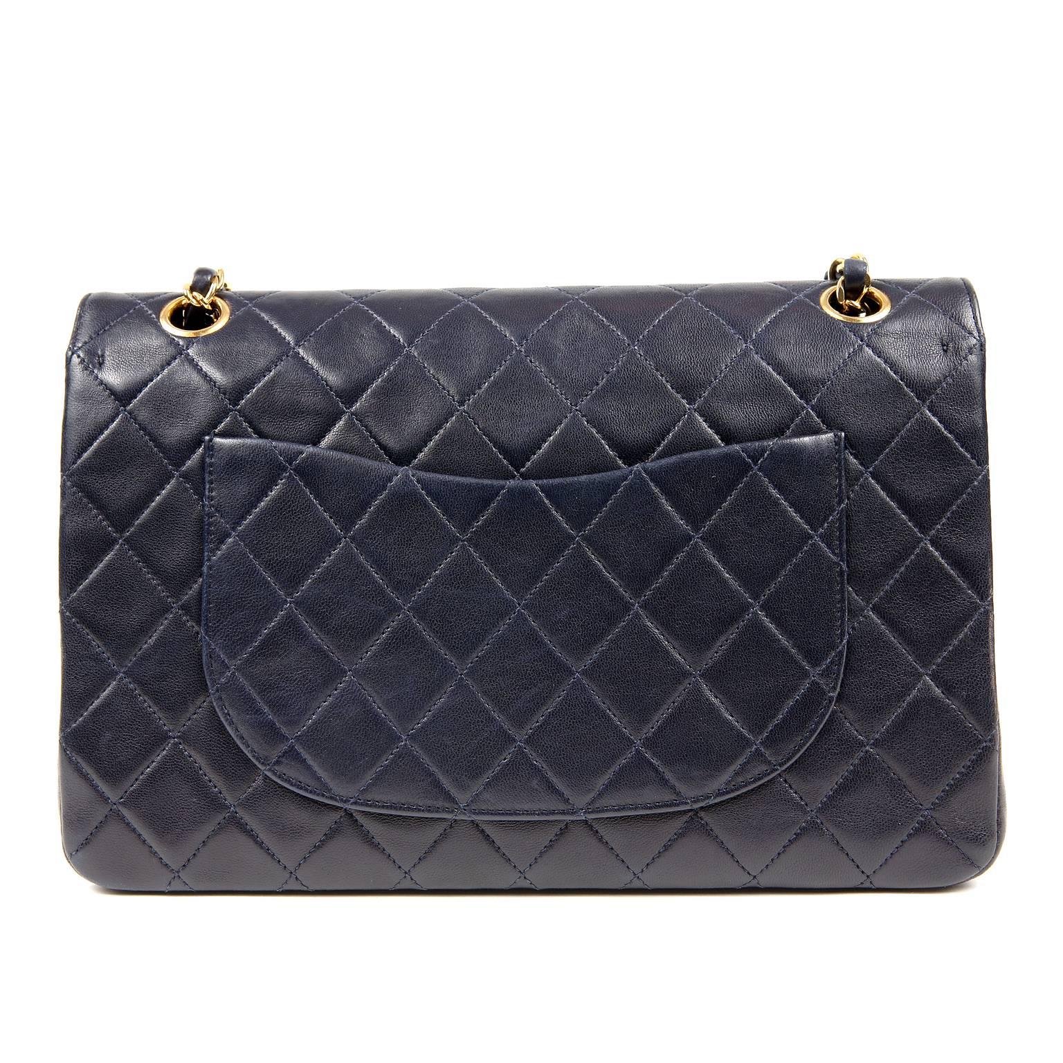 Chanel Navy Lambskin Double Flap Classic- Excellent Condition
 The regal shade of blue pairs brilliantly with gold hardware; a truly classic combination. 
Navy blue lambskin is quilted in signature Chanel diamond pattern.  Gold interlocking CC twist
