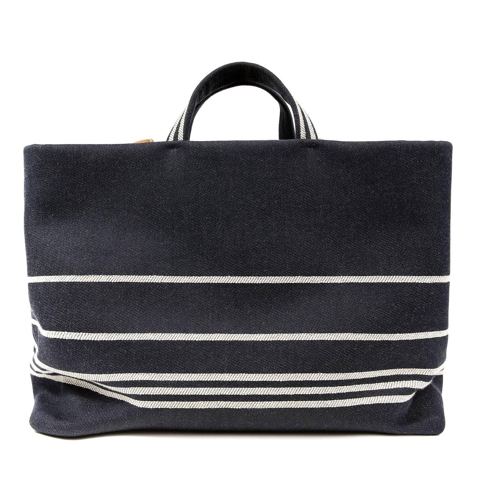 Chanel Black Classic Summer Tote- PRISTINE
 Perfect for the beach or a stroll through town, it is certain to become a holiday favorite. 

Sturdy black canvas tote has white striping and interlocking CC logo centered on the front.  Protective footed