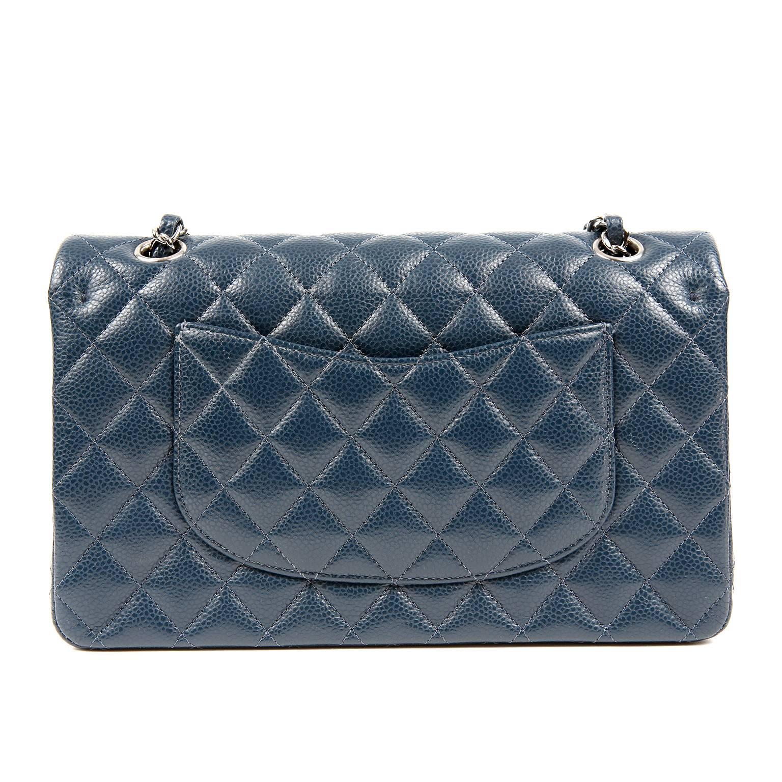 Chanel Navy Blue Caviar Double Flap Classic- PRISTINE
 The elegant shade of navy pairs perfectly with silver hardware for a timeless look; especially desirable in the versatile medium silhouette.    

Navy blue caviar leather is textured and