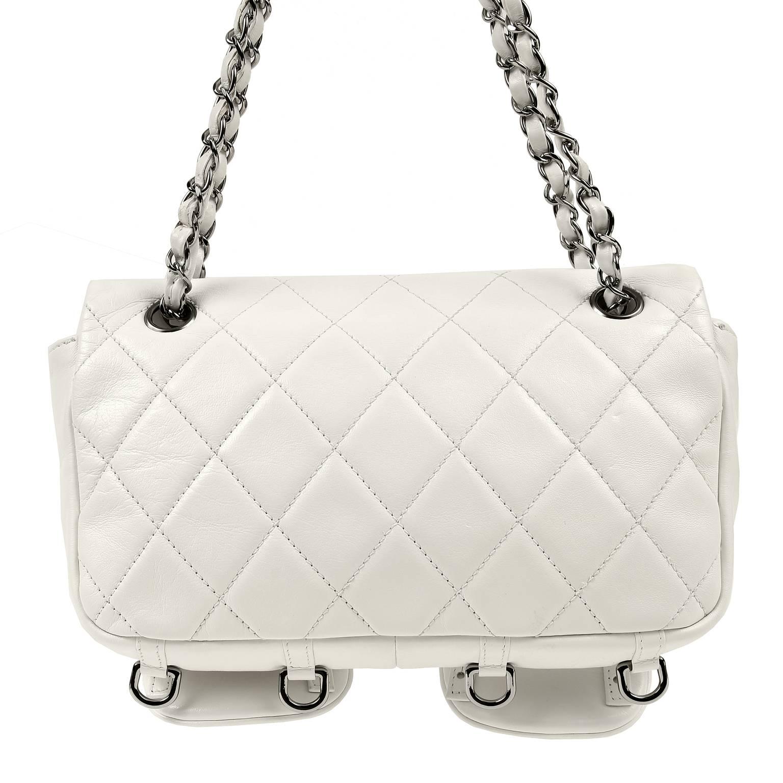 Chanel White Lambskin Two Pocket Day Bag- PRISTINE
A beautiful style with pronounced stitching and prominent silver hardware, this piece is hard to resist.    

Snowy white lambskin is quilted in signature Chanel diamond pattern.  Two large patch