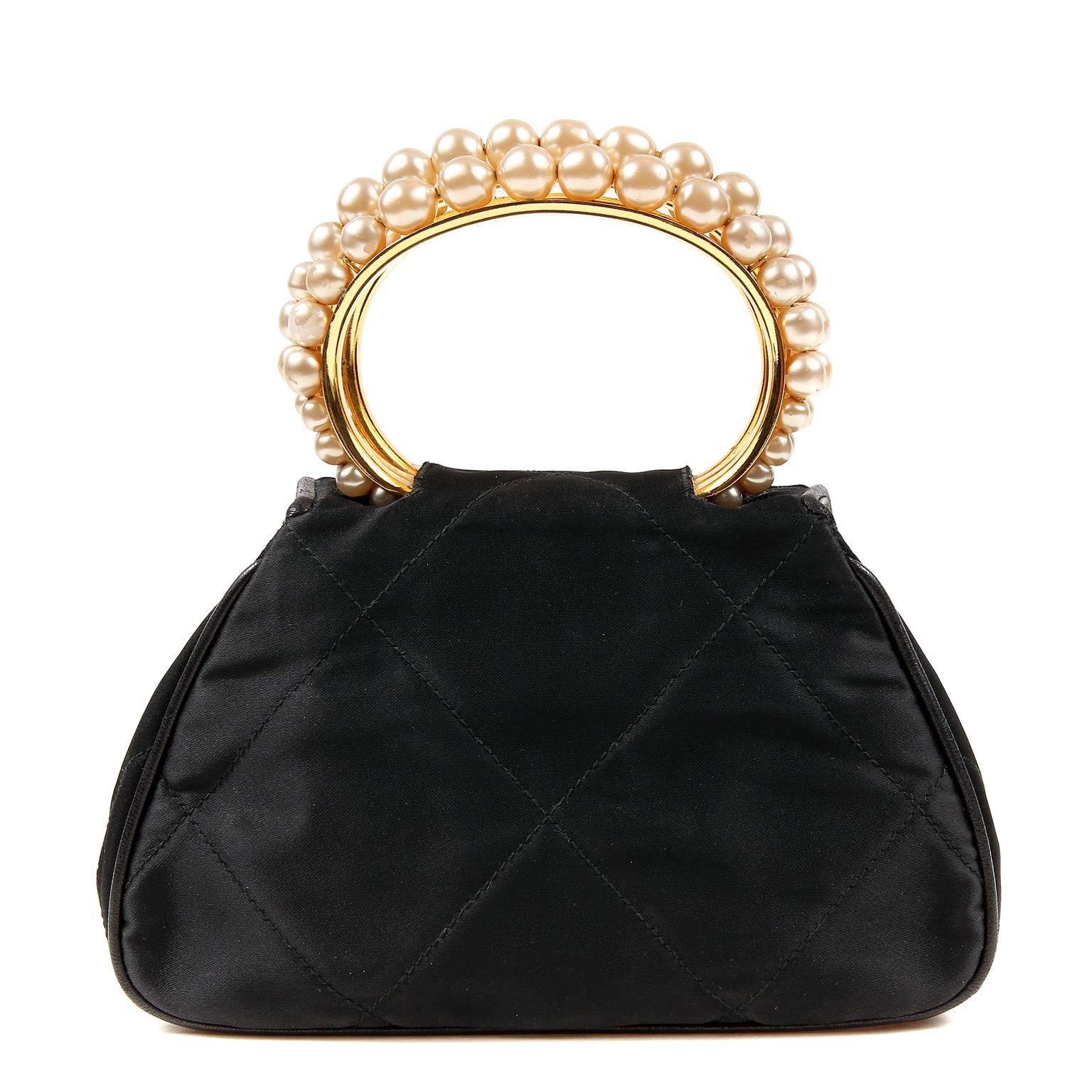 Chanel Black Vintage Pearl Handle Wrist Bag- PRISTINE
A timeless ladylike piece, this Chanel is extremely collectible and especially rare in such exquisite condition. 

Black silk small bag is quilted in signature Chanel diamond pattern with black