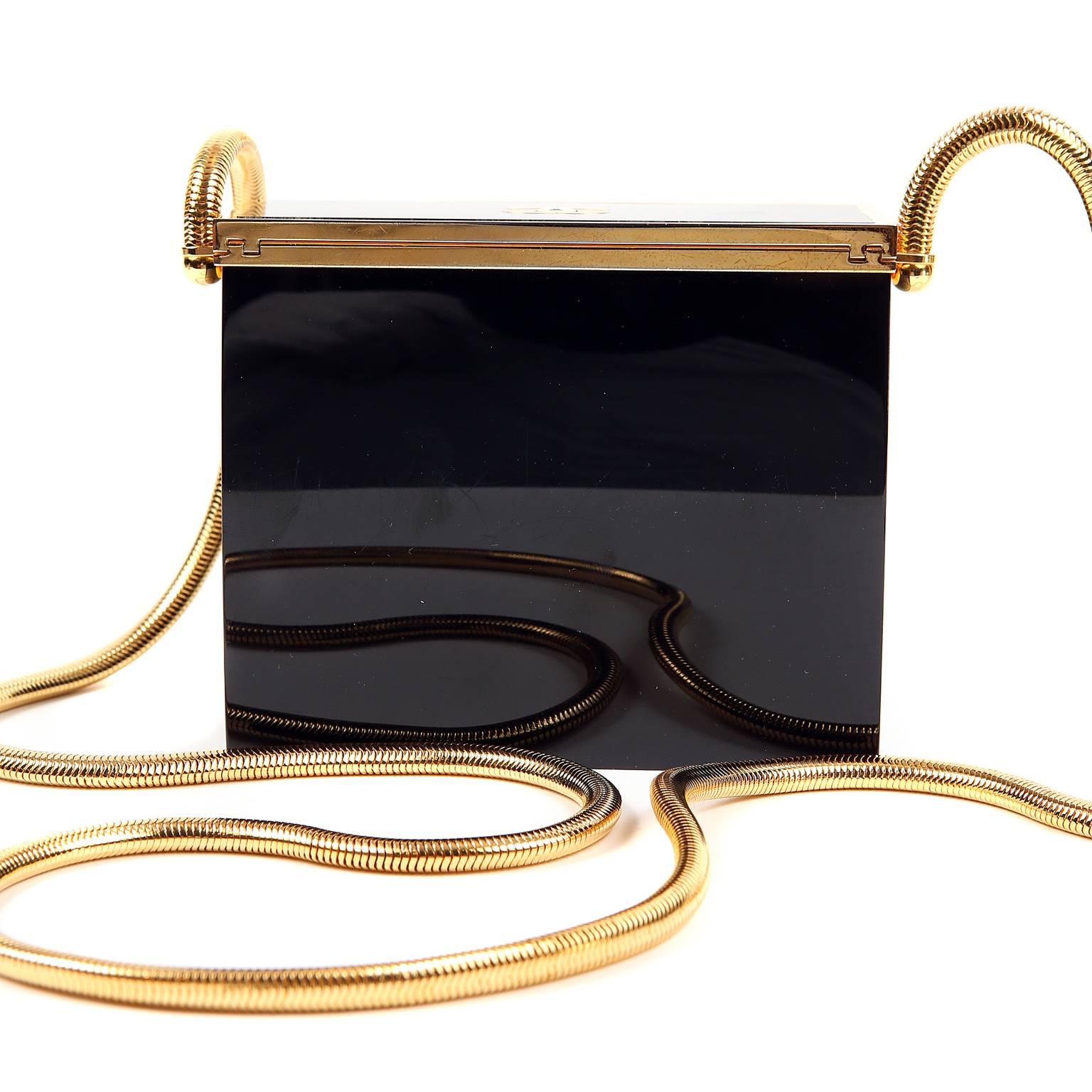 Chanel Black Resin Evening Bag- Near Pristine
  A rare piece that is a must have for any collector. 

Polished black resin rectangular structured bag is edged with gold hardware.  Hinged top.  Long gold snake chain strap is comfortably carried on