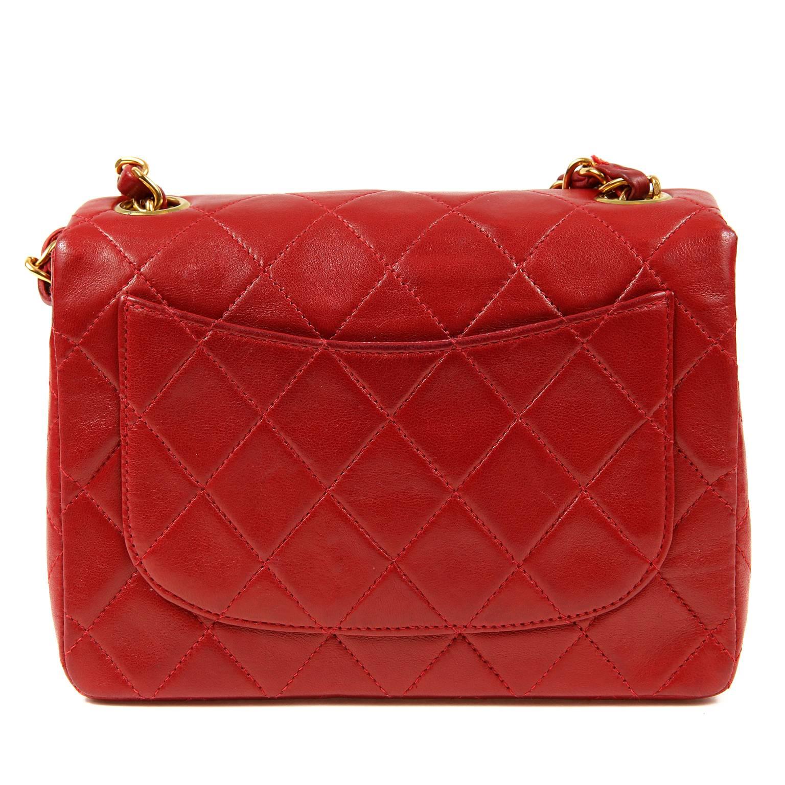 Chanel Red Lambskin Mini Classic is in excellent condition.   Stunning in vibrant red with gold hardware and wearable year-round.    

Lipstick Red lambskin is quilted in signature Chanel diamond pattern.  Gold interlocking Cc twist lock secures the