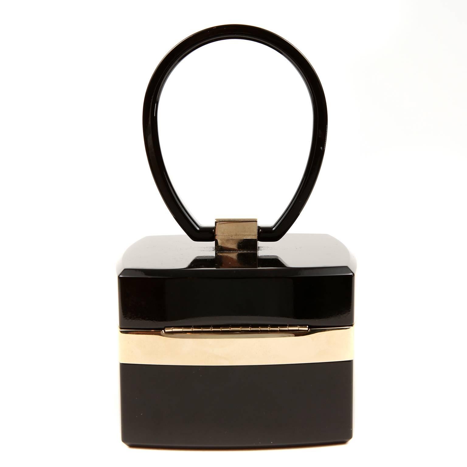 Chanel Black Lucite and Gold Devil Wears Prada Bag- PRISTINE
  From the 2004 collection, this exquisite collectible was featured in the movie titled, “Devil Wears Prada.”

Black Lucite square box style bag is accented with metallic gold.  CC clasp