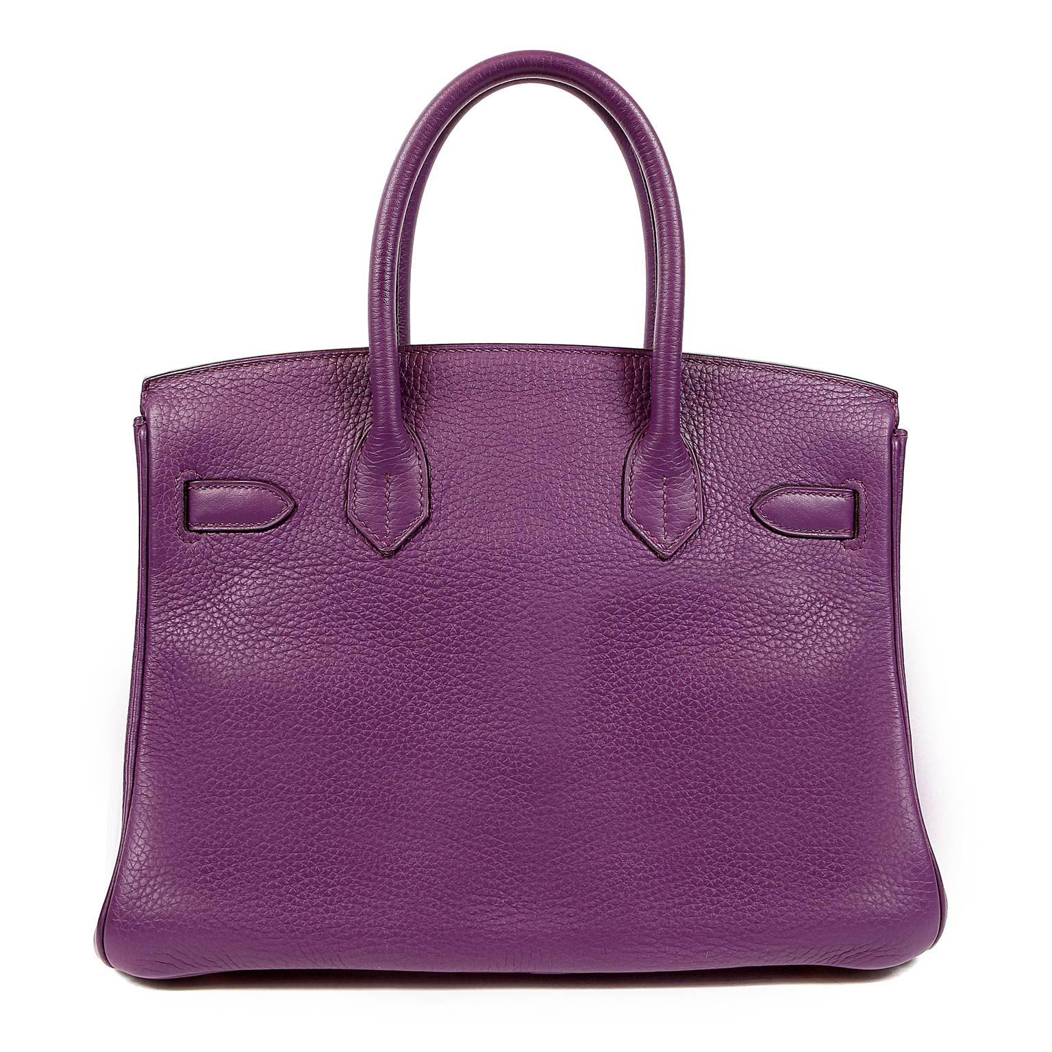 This authentic Hermès Ultra Violet Togo 30 cm Birkin is in pristine condition.    The protective plastic is still intact on most of the hardware. Hand stitched by skilled craftsmen, wait lists of a year or more are not uncommon for the Hermès