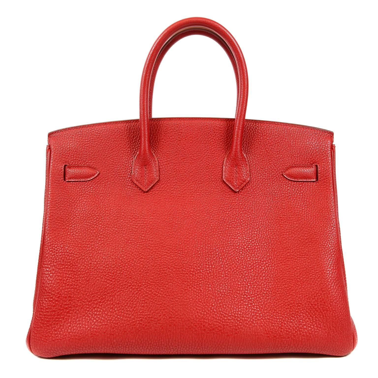 Hermès Rouge H Togo Leather Horseshoe Birkin- Pristine.  Never carried with plastic intact on the hardware.
Waitlists exceeding a year are commonplace for the intensely coveted leather Birkin bag.  Each piece is hand crafted by skilled artisans and