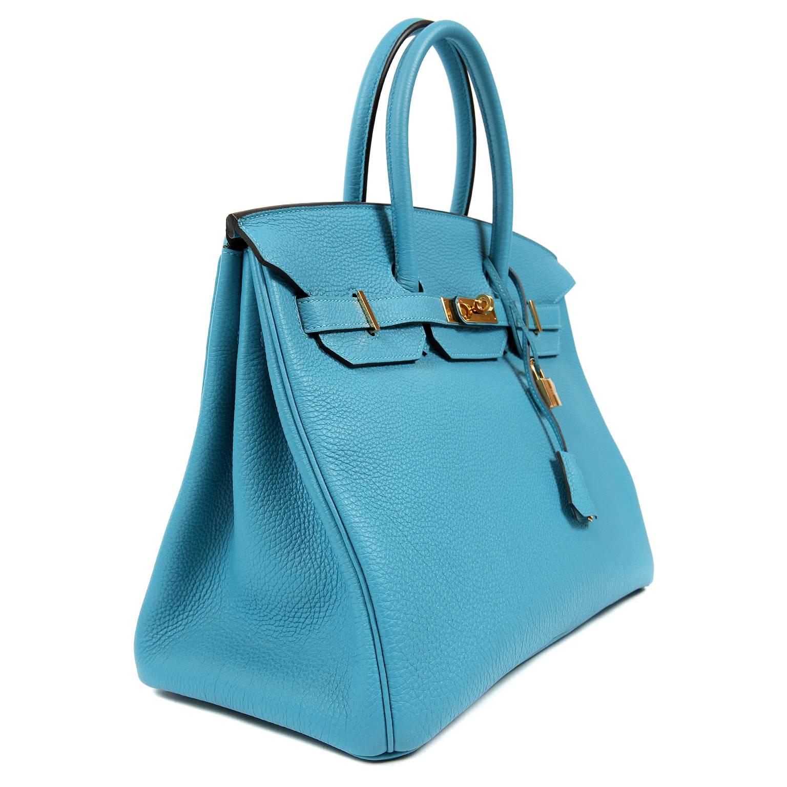 This authentic Hermès Turquoise Togo 35 cm Birkin is basically pristine.  Hand stitched by skilled craftsmen, wait lists of a year or more are not uncommon for the Hermès Birkin. Turquoise Togo is lively and joyful - breathtakingly combined with