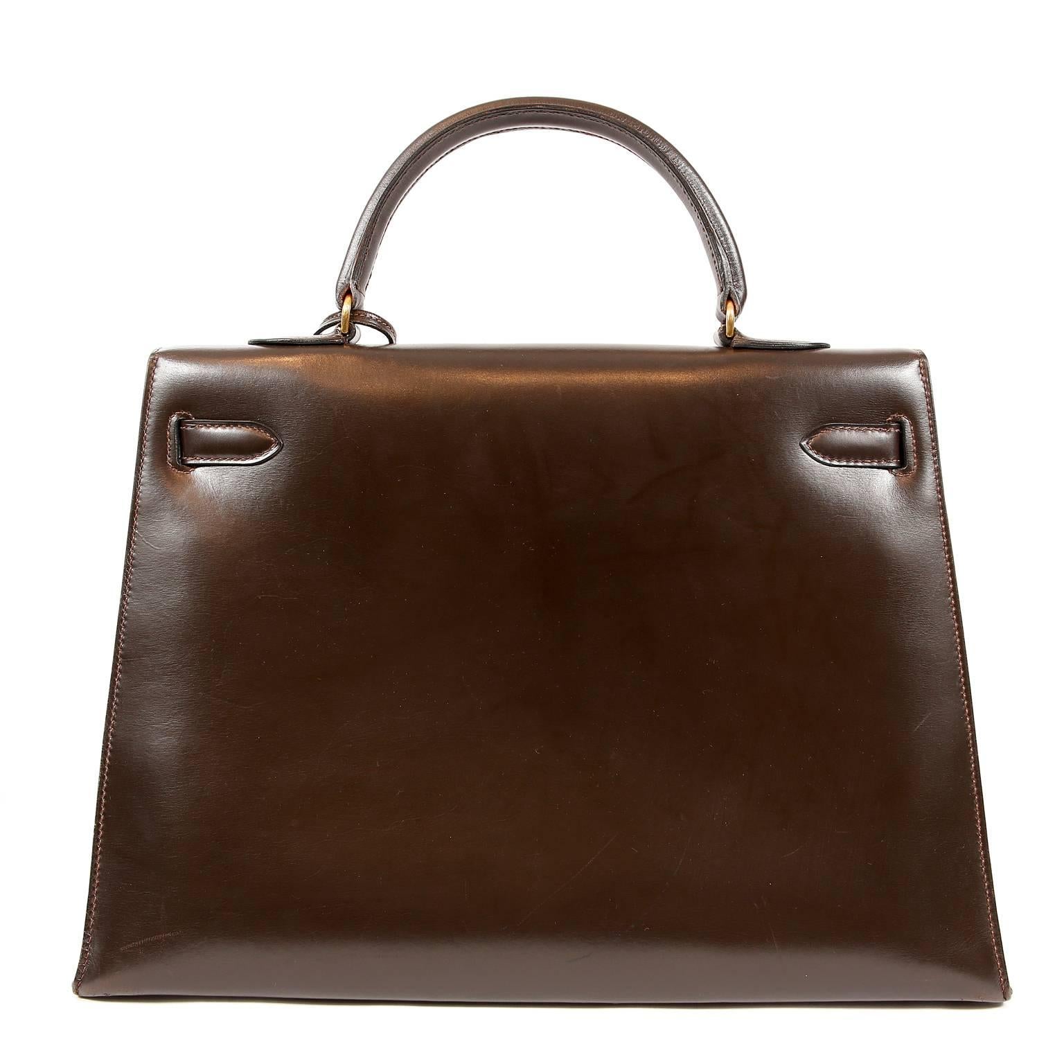 This authentic Hermès Chocolate Box Calf 35 cm Kelly Bag is in excellent vintage condition.    Hermès bags are considered the ultimate luxury item worldwide.  Each piece is handcrafted with waitlists that can exceed a year or more.  This Kelly is