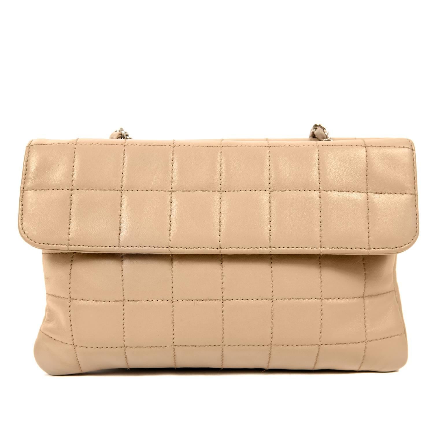 This authentic Chanel Beige Lambskin Double Sided Crossbody Bag is in better than excellent condition.  Quite roomy, this well-designed bag can carry all the necessary items for a day or night on the town.  
Beige lambskin is square quilted in
