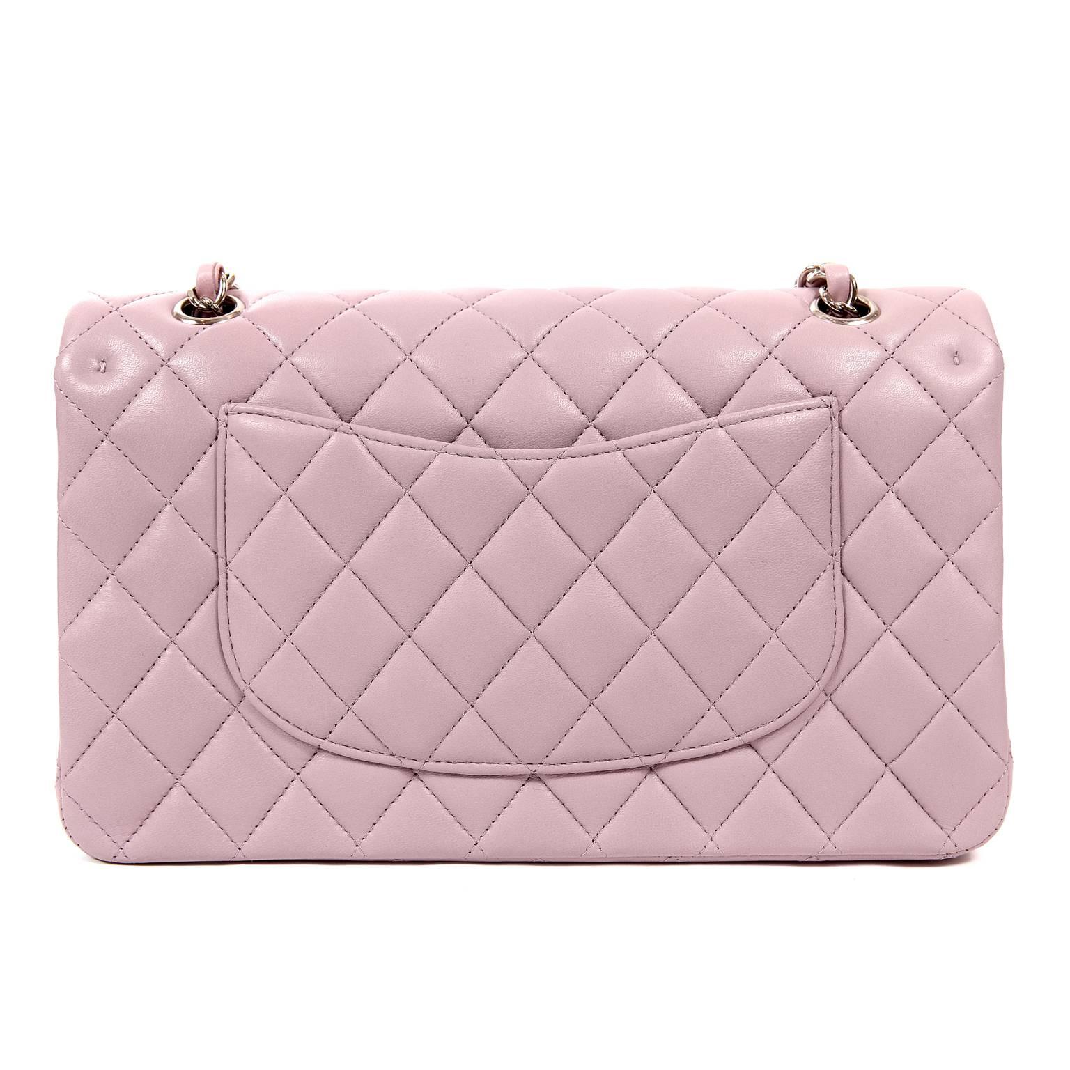 This authentic Chanel Lilac Lambskin Medium Classic Flap is pristine- never before carried.   The timeless style is strikingly lovely in soft lilac with silver hardware.  
Feminine soft lilac lambskin is quilted in signature Chanel diamond pattern. 