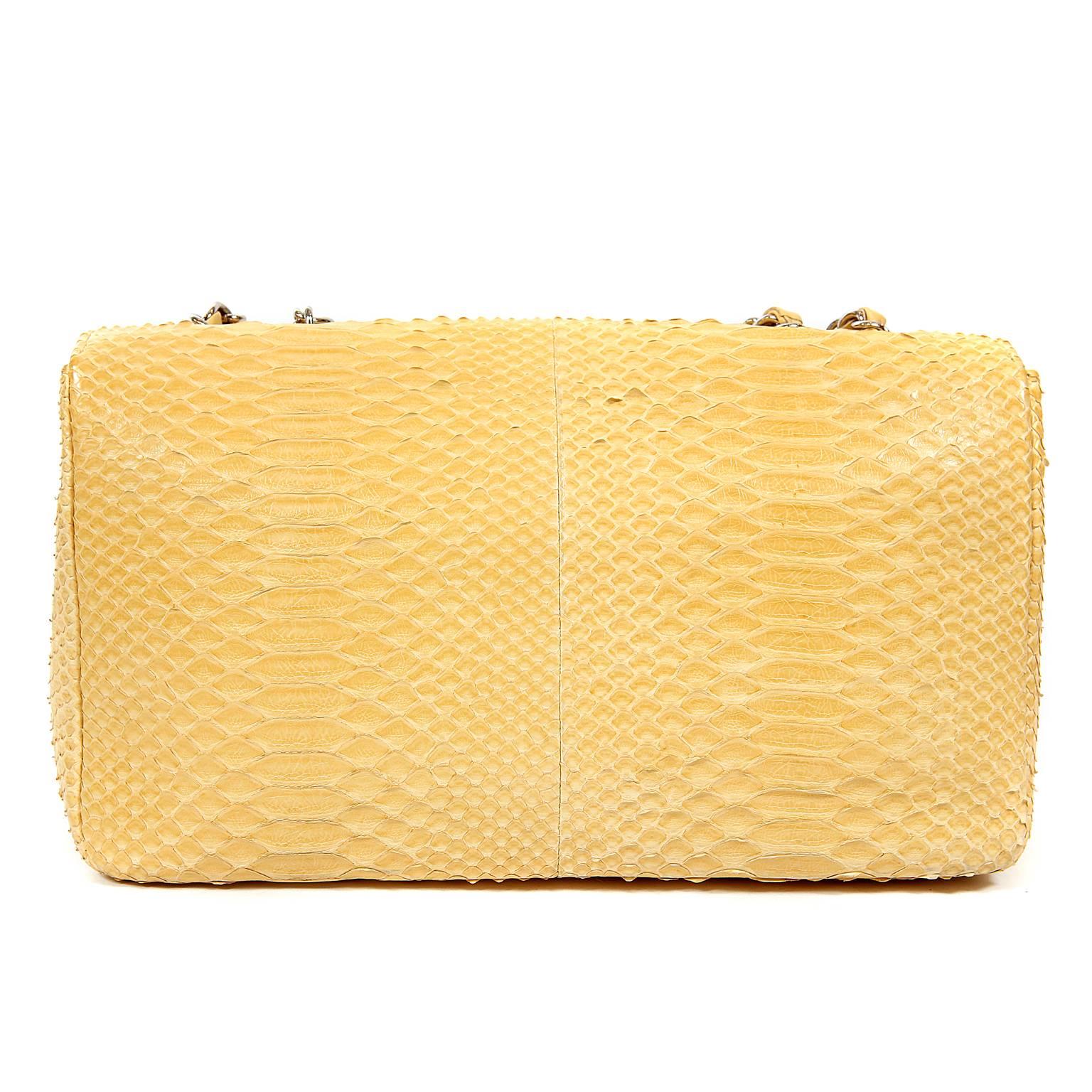 
This authentic Chanel Moutard Python Classic Flap Bag is in beautifully pristine condition.  A stunning exotic in striking yellow, it is a must have for collectors.  
Mustard yellow python skin single flap bag has large silver interlocking CC twist